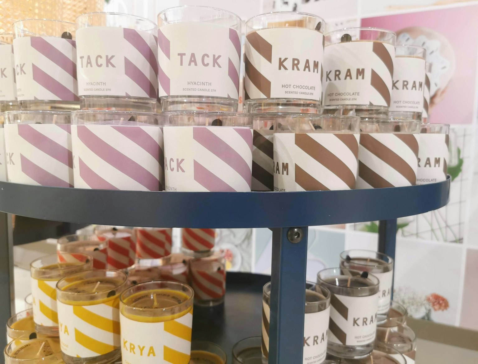 Colorful candles displayed in stripes with various colors and labels