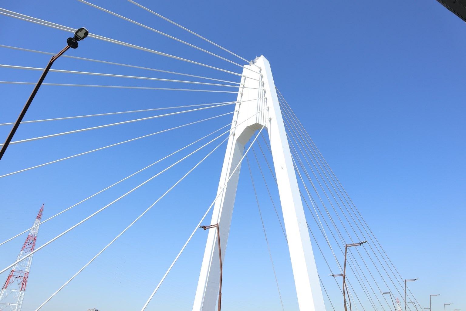 Jembatan kabel putih di bawah langit biru yang cerah