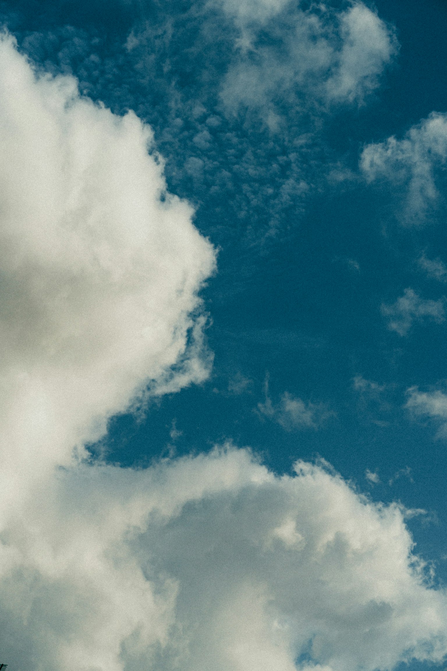 A landscape of white clouds floating in a blue sky
