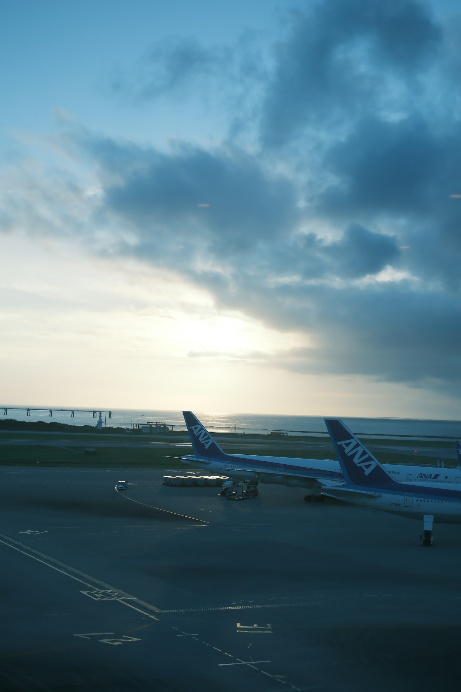 Flugzeuge auf der Landebahn mit Blick auf den Ozean und Wolken