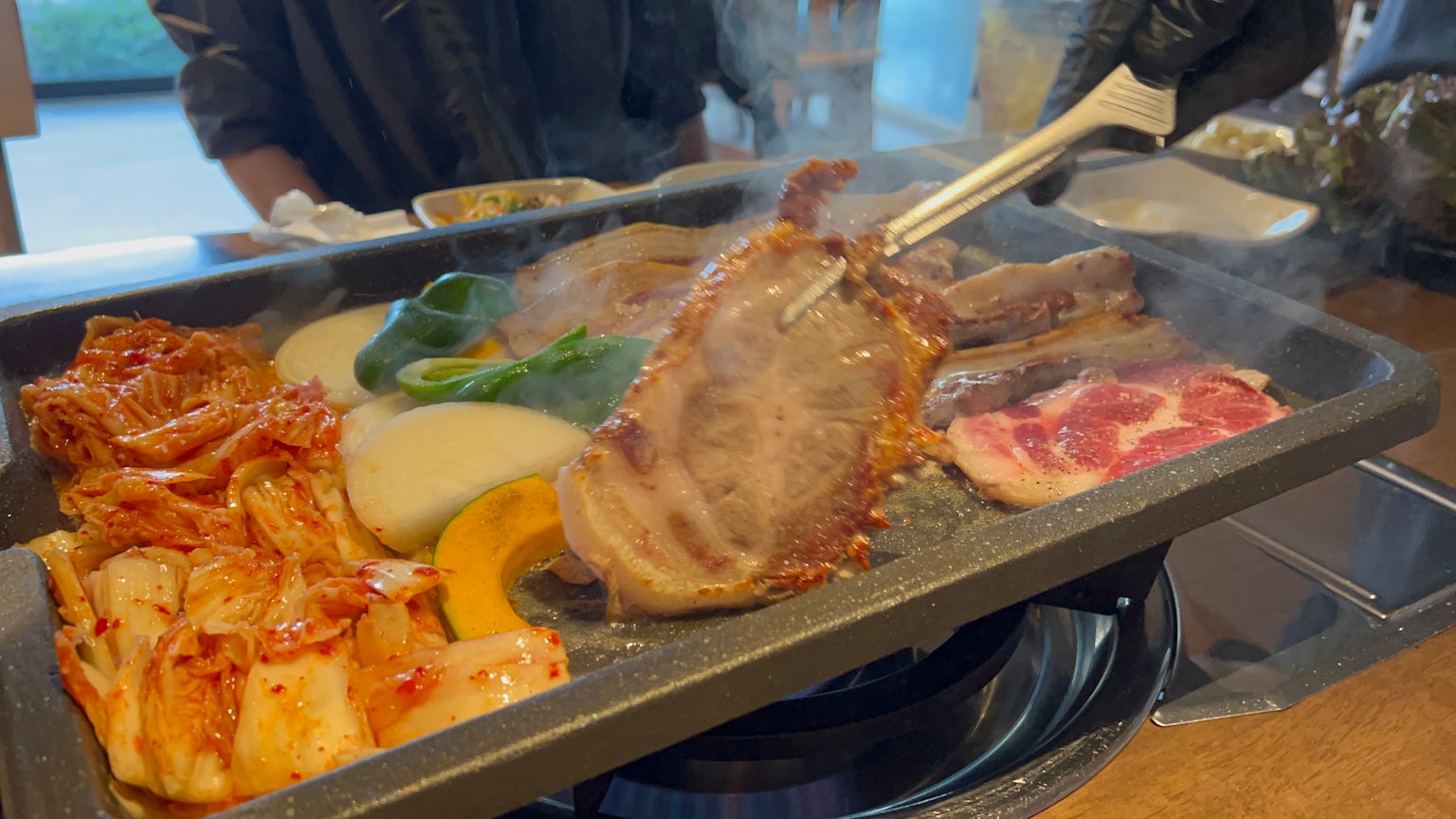 Grilled meat and vegetables on a barbecue plate