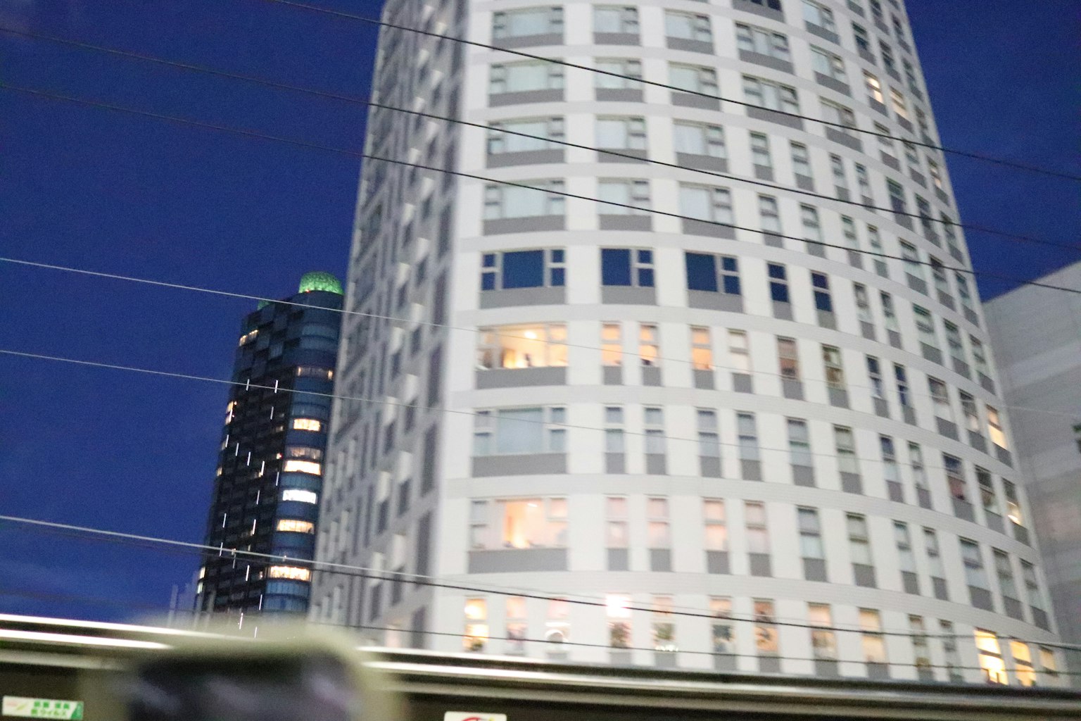 Edificio moderno a grattacielo con facciata bianca contro un cielo notturno