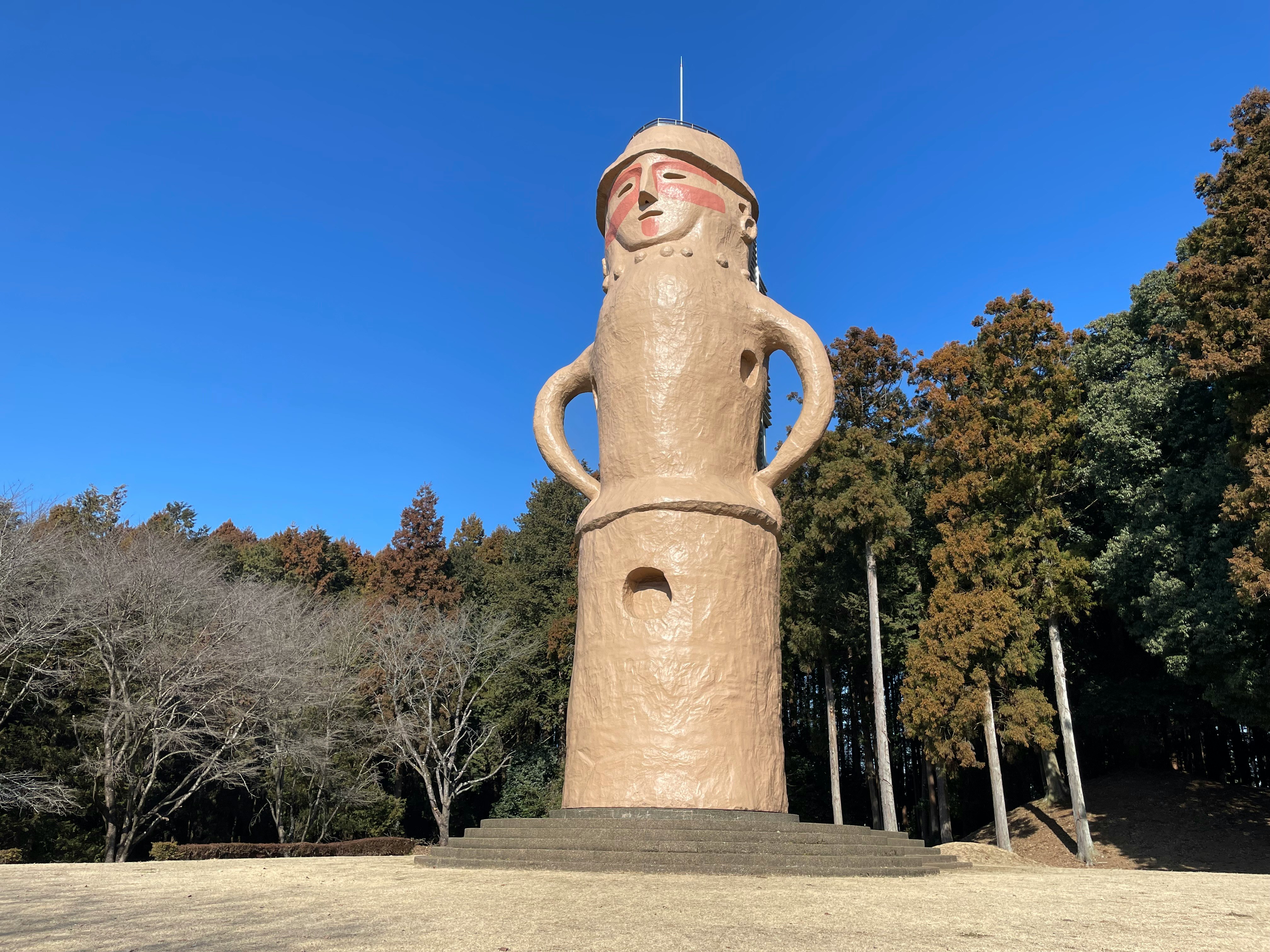 grande statua in ceramica in piedi sotto un cielo blu