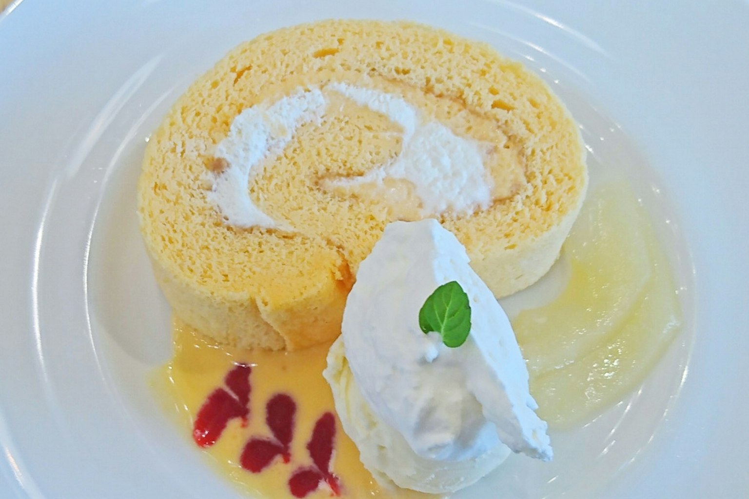 Dessert featuring a cream-filled roll cake and whipped cream