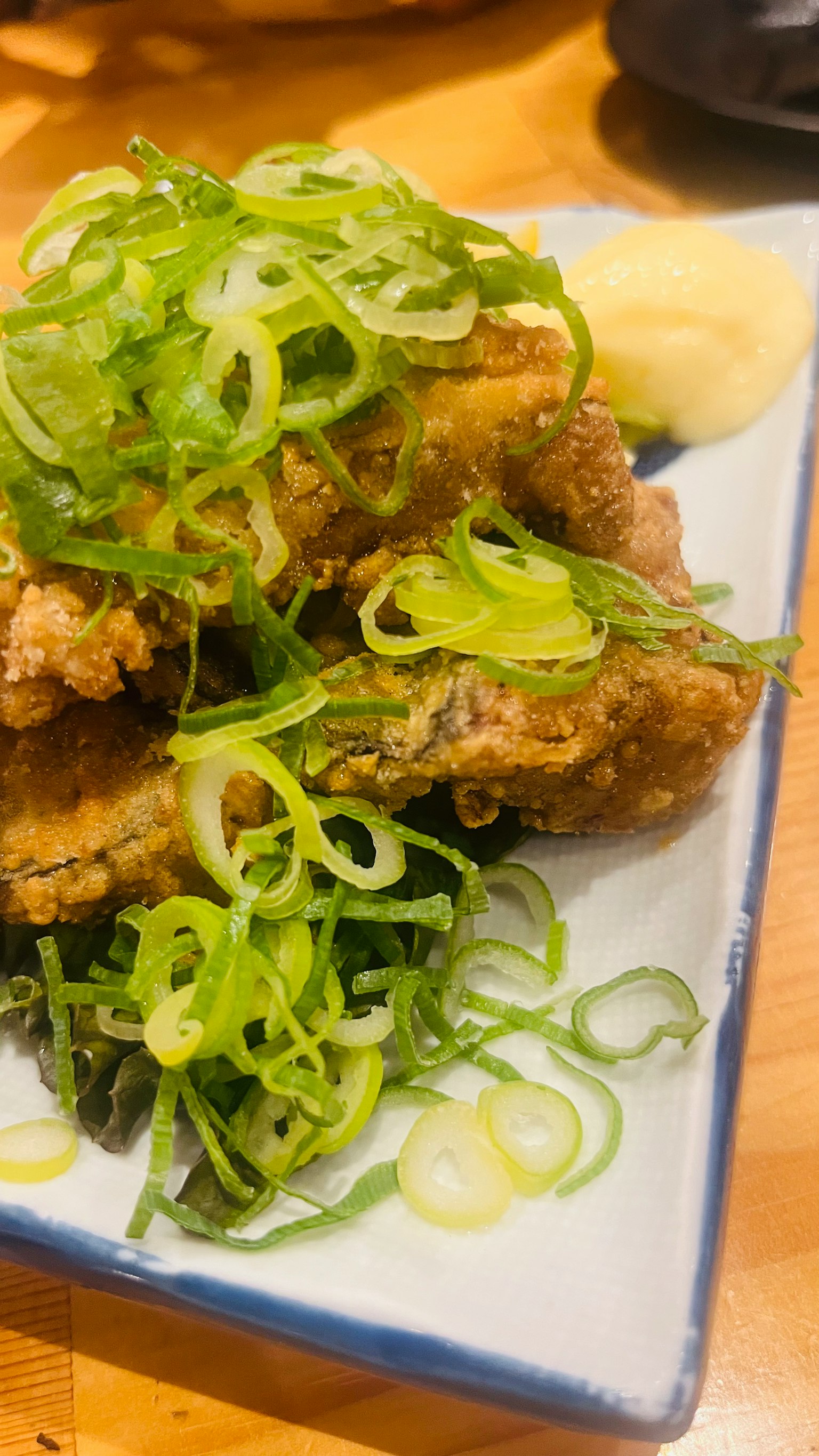 Fried chicken topped with a generous amount of green onions