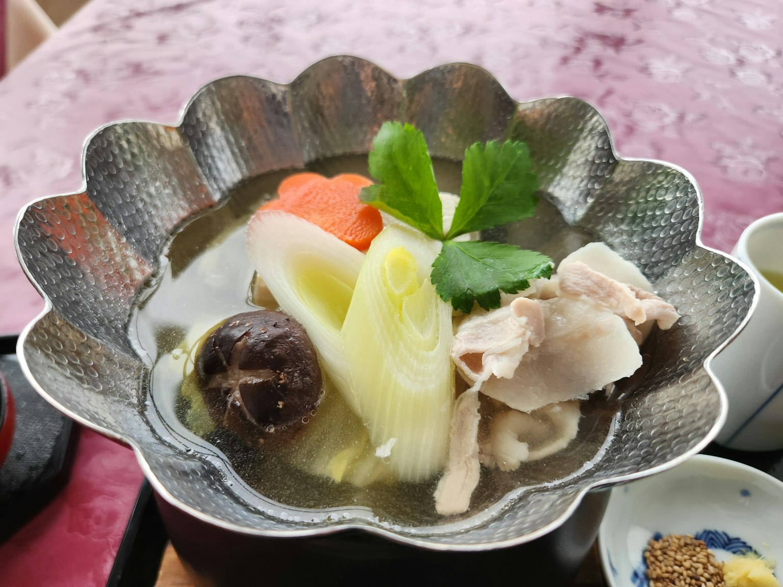 Image of a soup dish with colorful vegetables and chicken