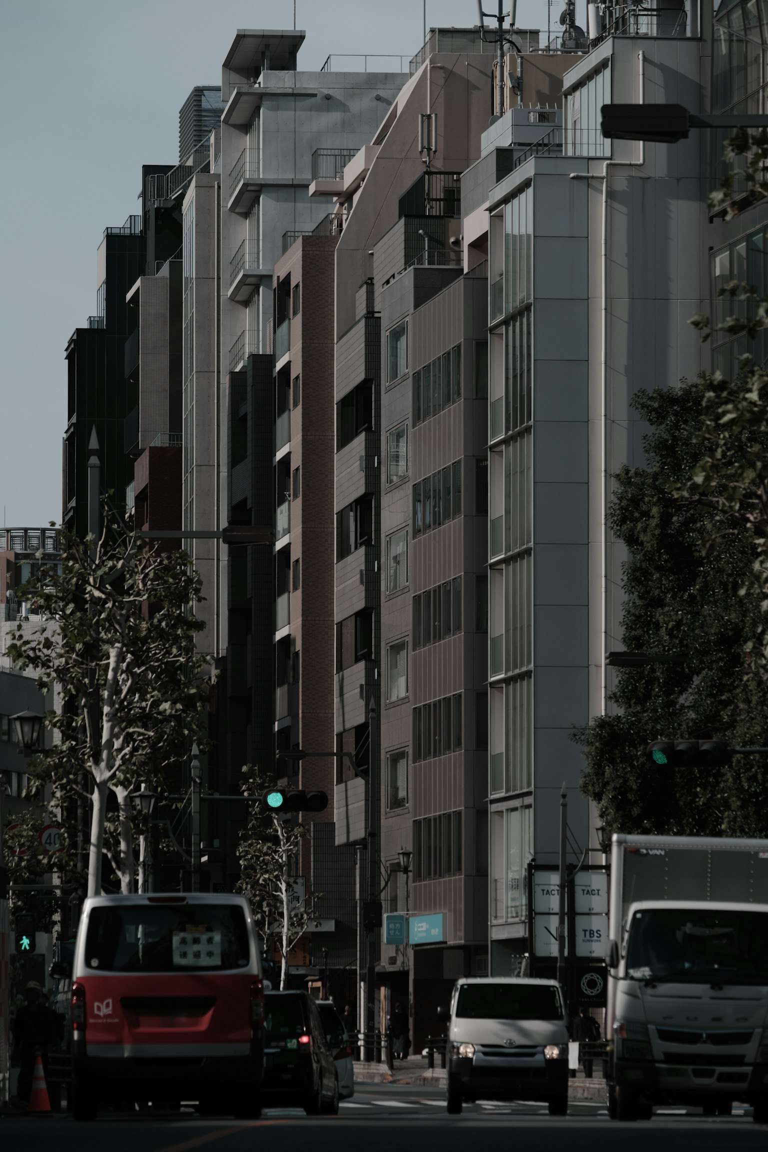 Urban street scene featuring tall buildings and vehicles