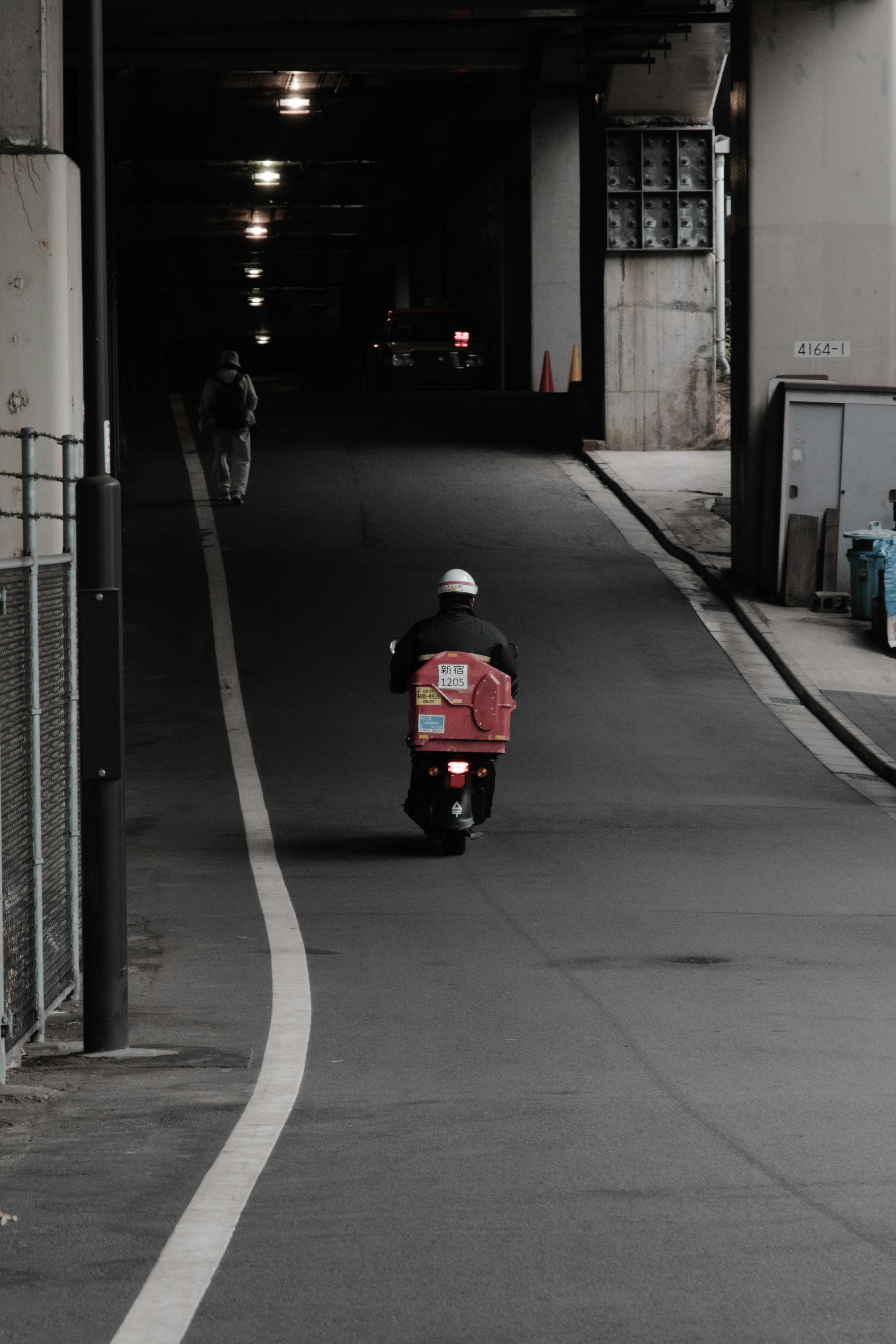 南元町のトンネル内を進む自転車の後ろ姿のある路地
