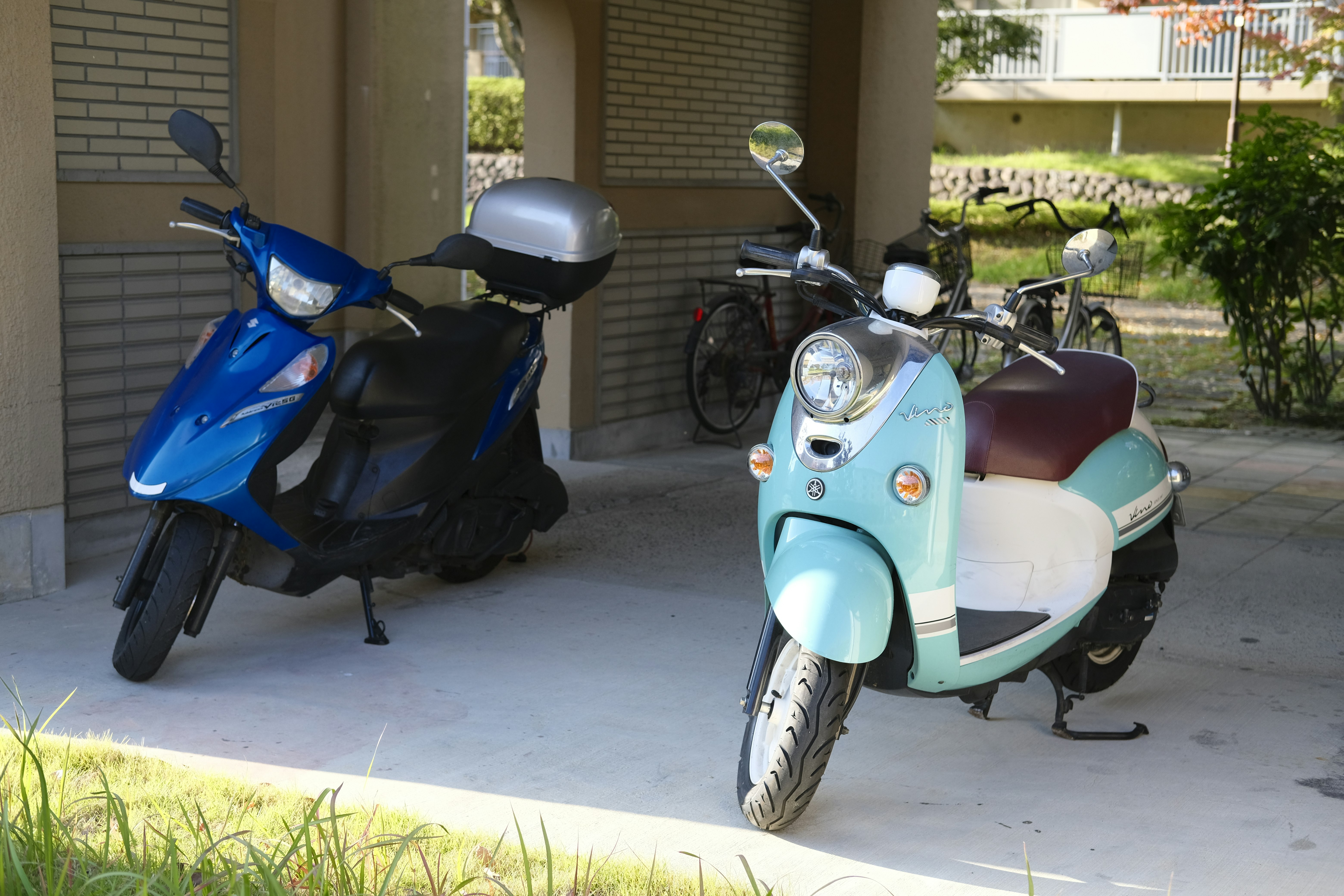 bicycles and scooters lined up at a storefront