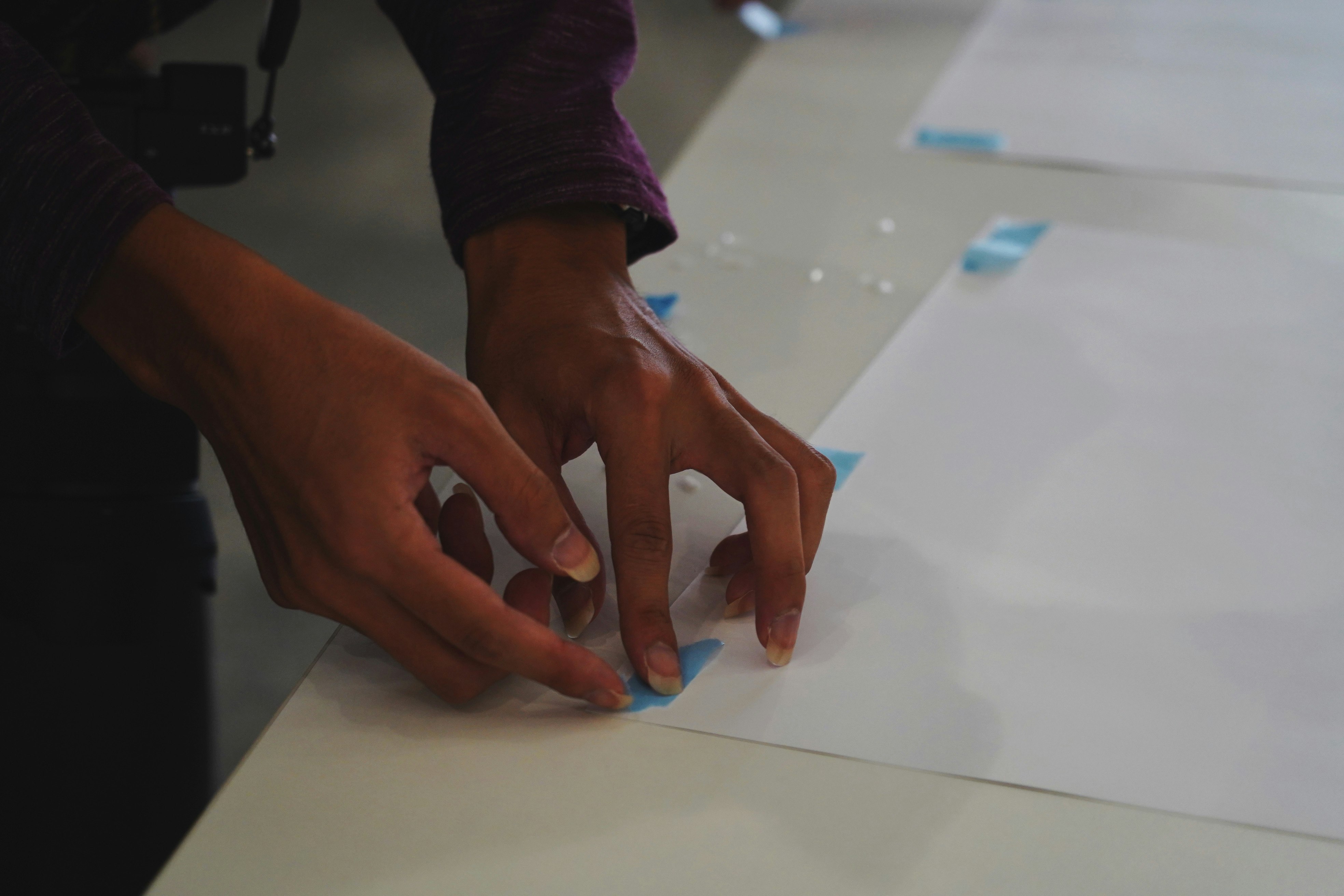 Kyoto event hands arranging printed photos on paper