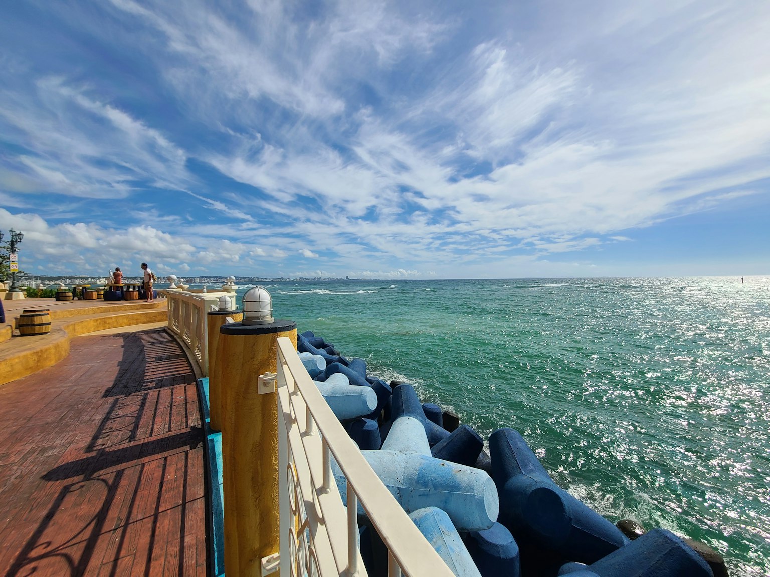 Wooden deck along the blue sea and bright sky scenery