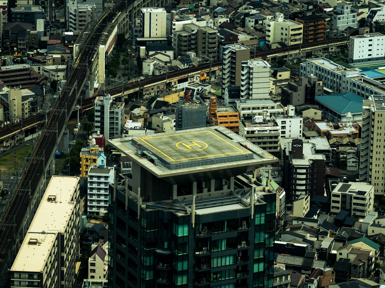Aerial view of urban high-rise buildings and railway tracks