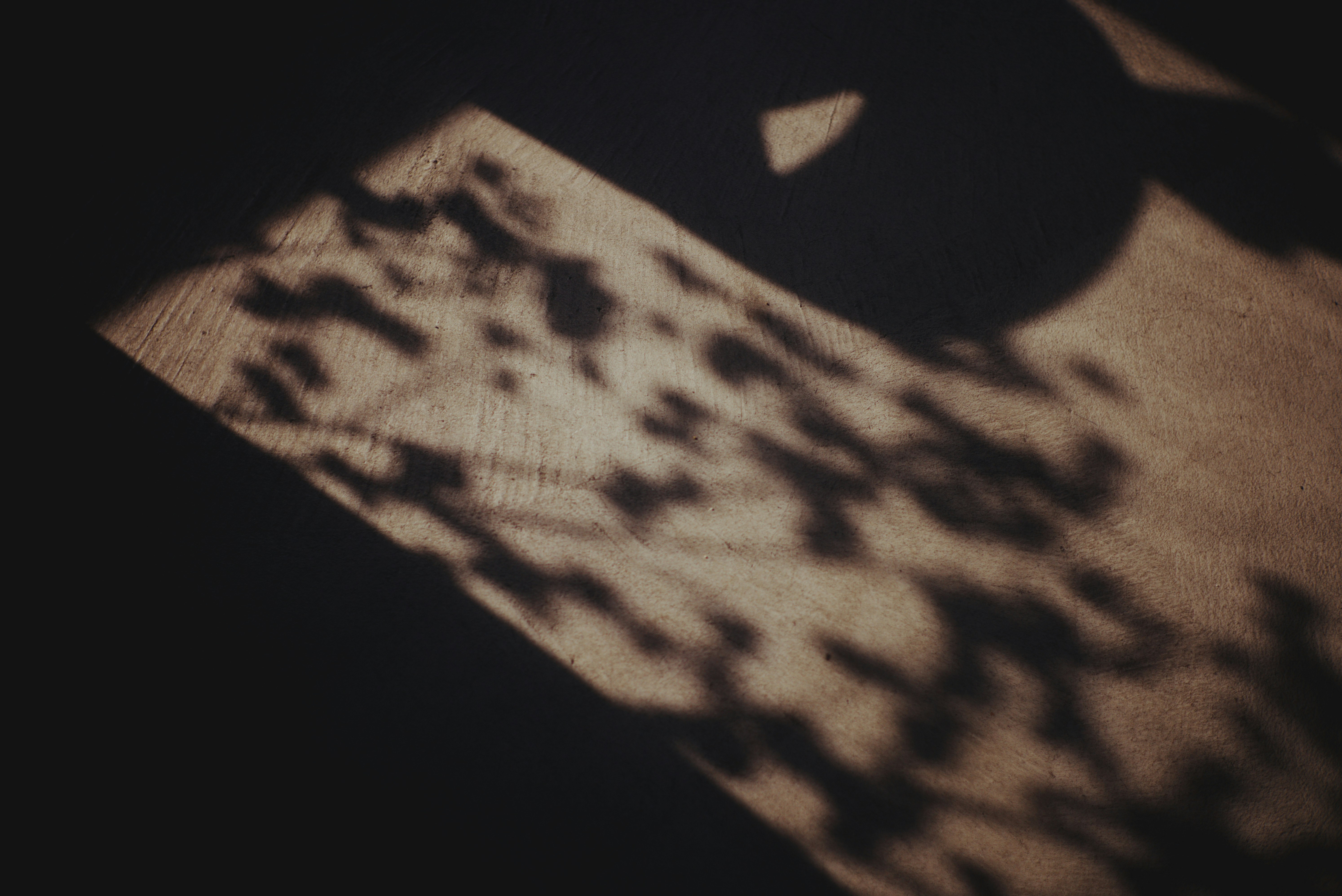 Retro patterned tie laid on fabric with dramatic shadows