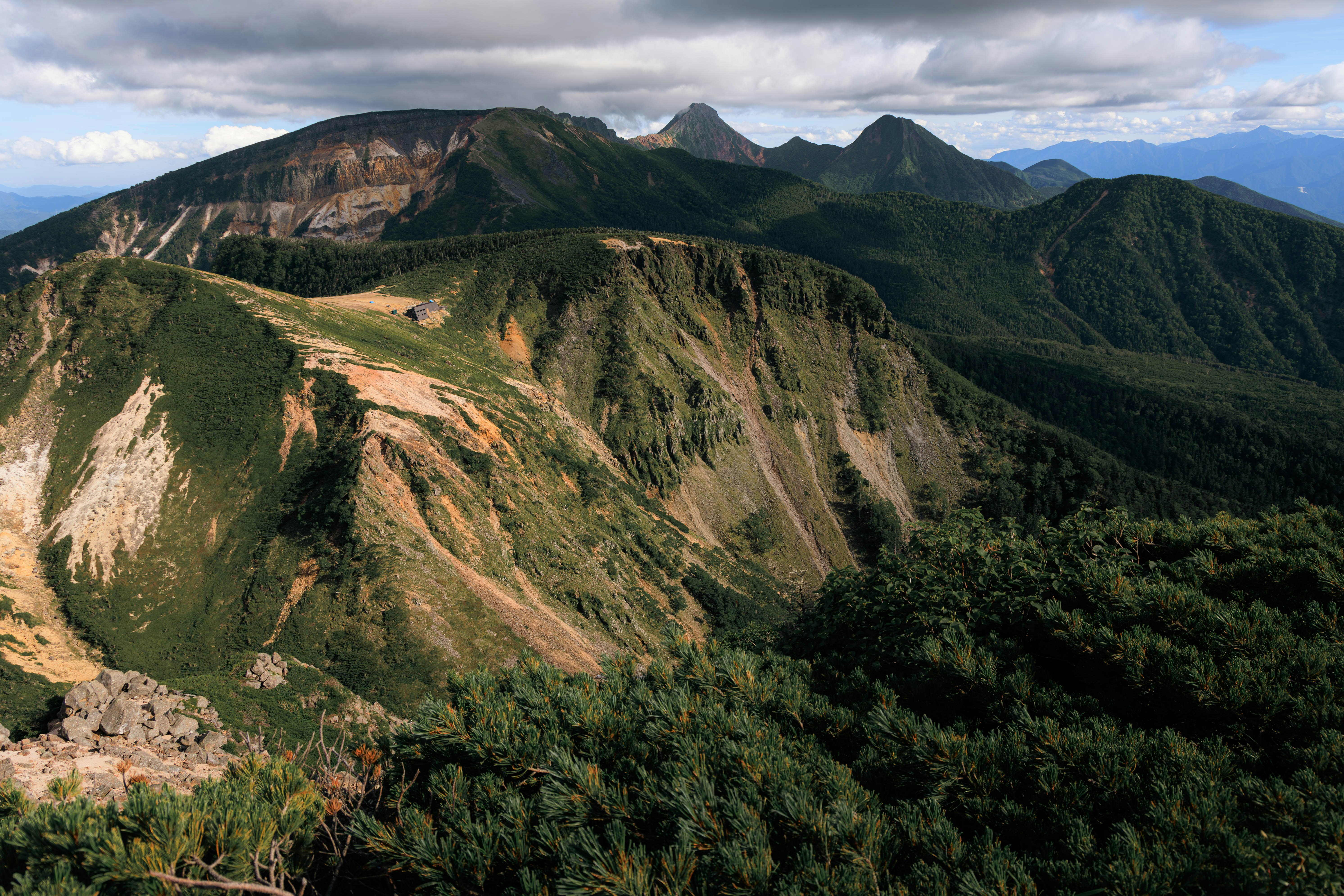緑の山並みと稜線が広がる山岳風景