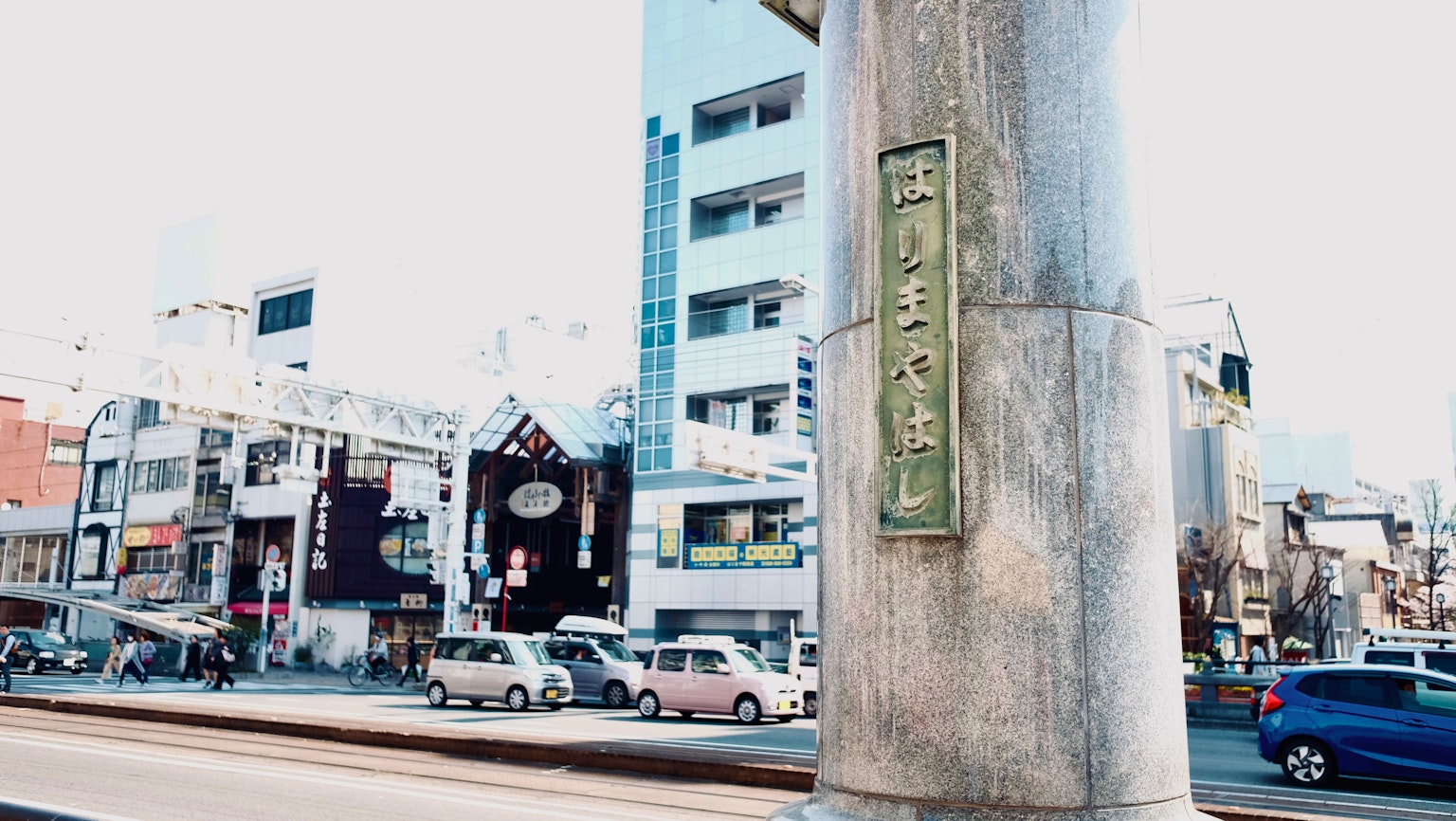 Urban street scene with buildings and a road sign