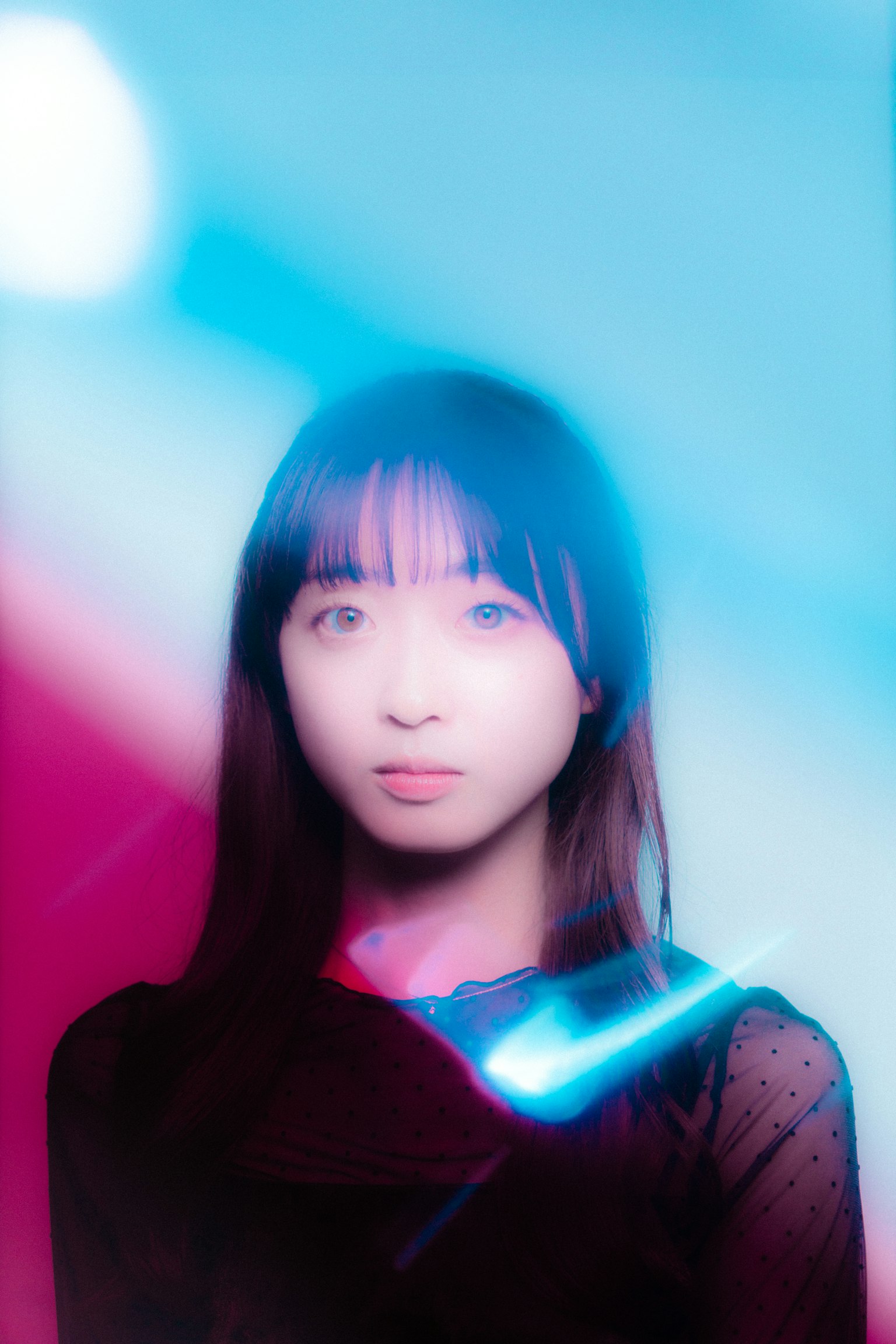 Portrait of a woman surrounded by blue and red light