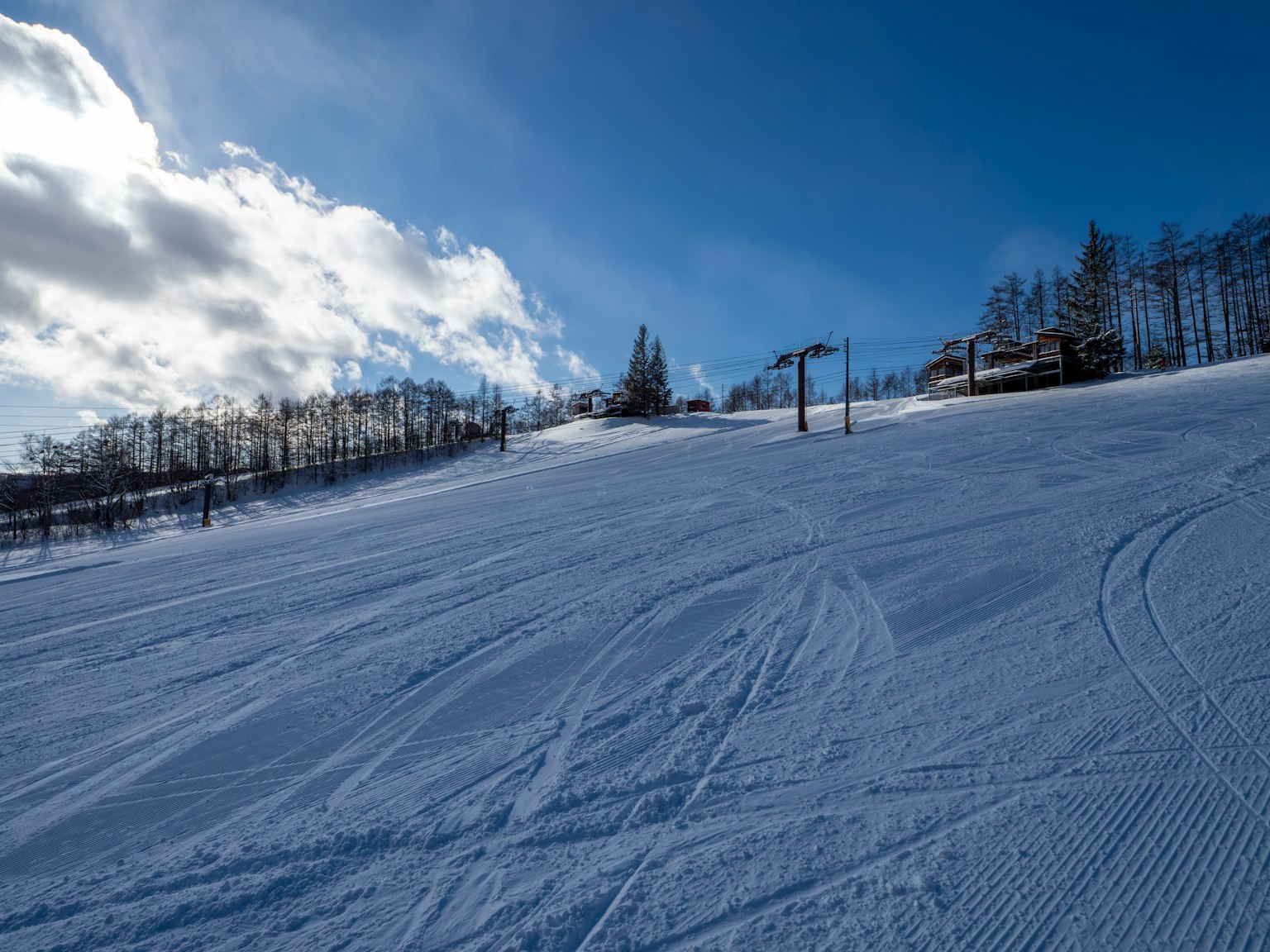 Snow-covered ski slope with a clear blue sky