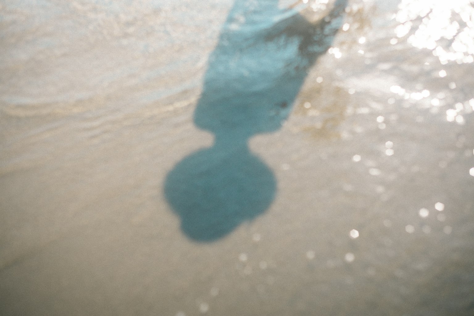 Silhouette reflection on water surface with light bokeh