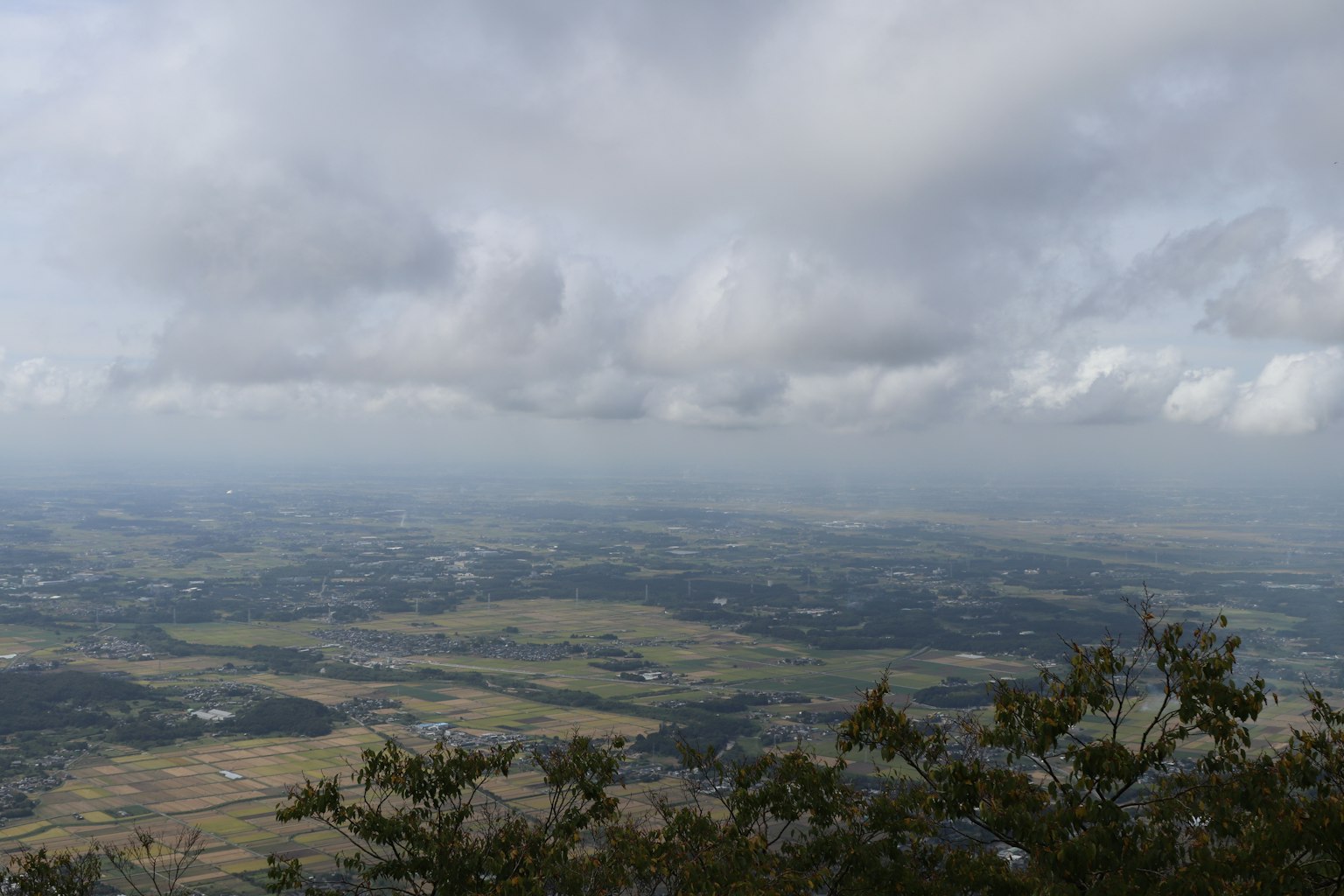 Vue expansive depuis un sommet de montagne avec ciel nuageux
