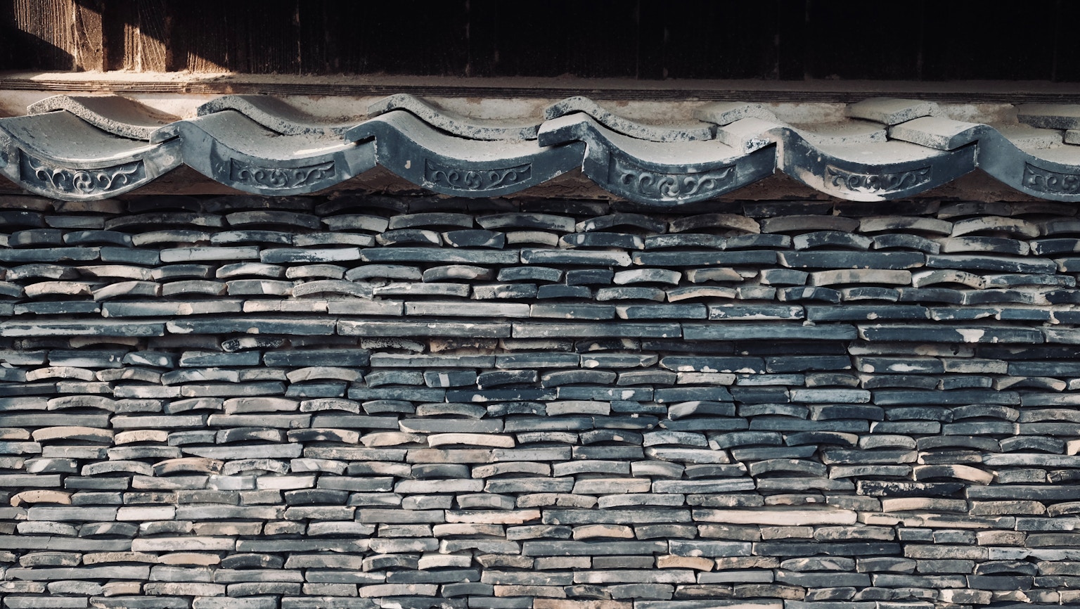 Traditional stone wall structure under a roof