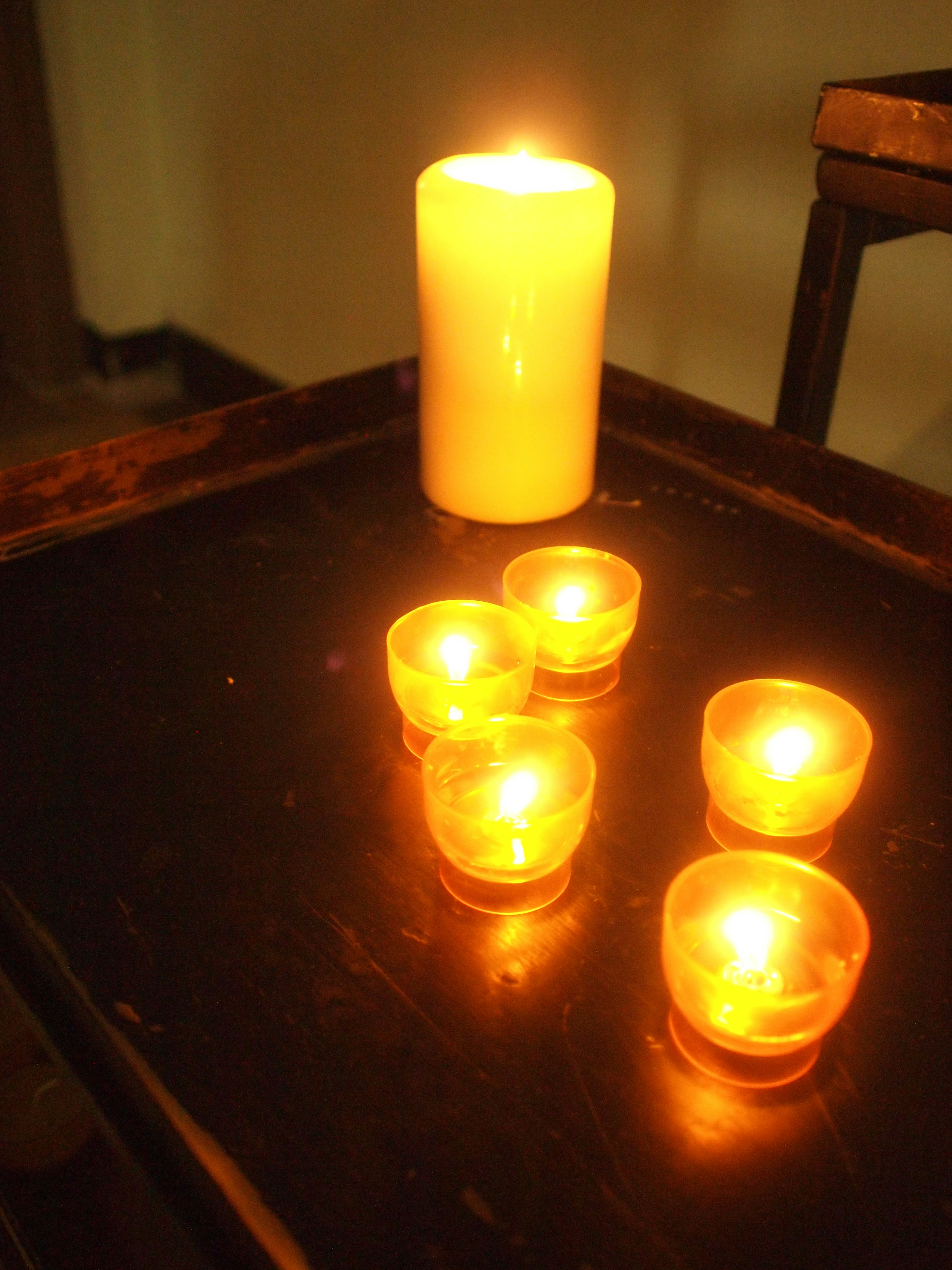 lilin menyala di atas meja, suasana malam yang tenang