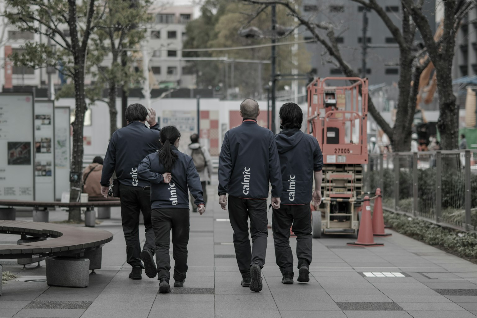 A group of workers walking away in an urban setting