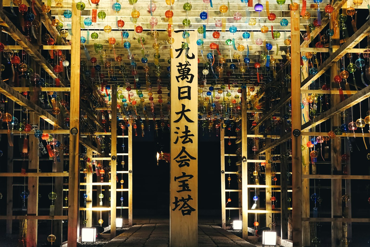 Spazio tradizionale giapponese adornato con campane colorate Un grande pilastro presenta caratteri kanji