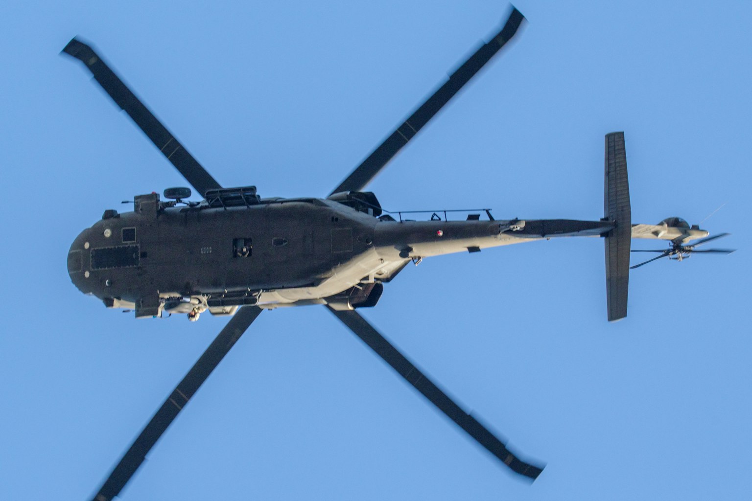 Image of a black helicopter viewed from above