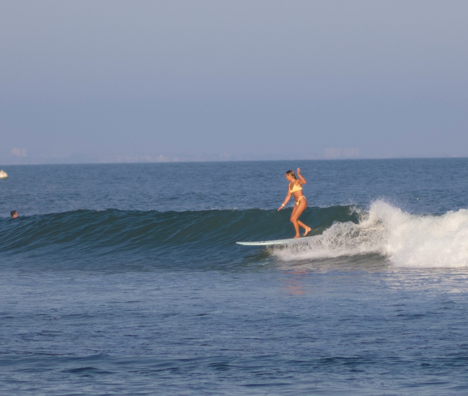 A woman surfing on a wave in the ocean