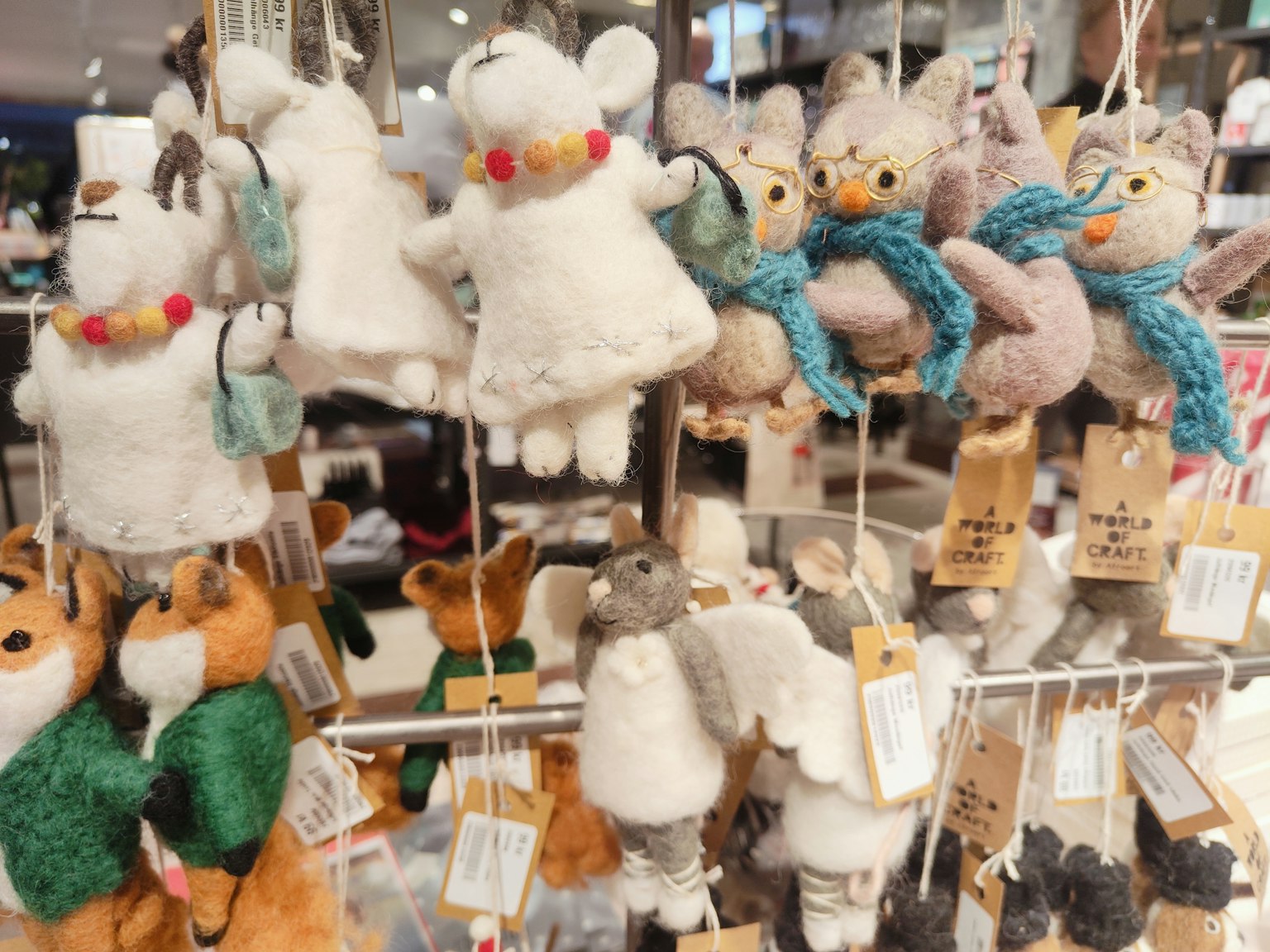 Display of cute plush ornaments hanging in a shop