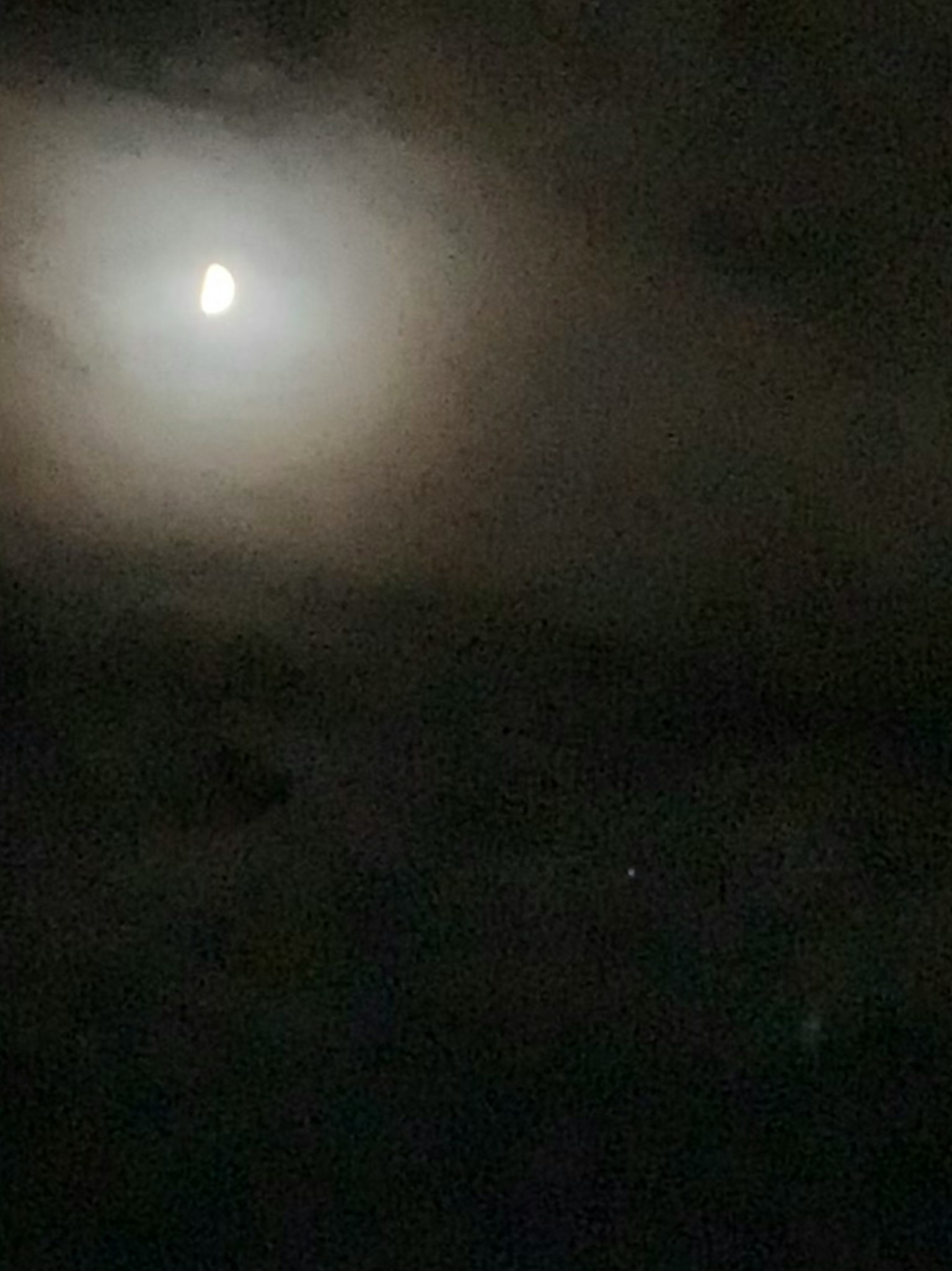 Bright moonlight surrounded by dark clouds