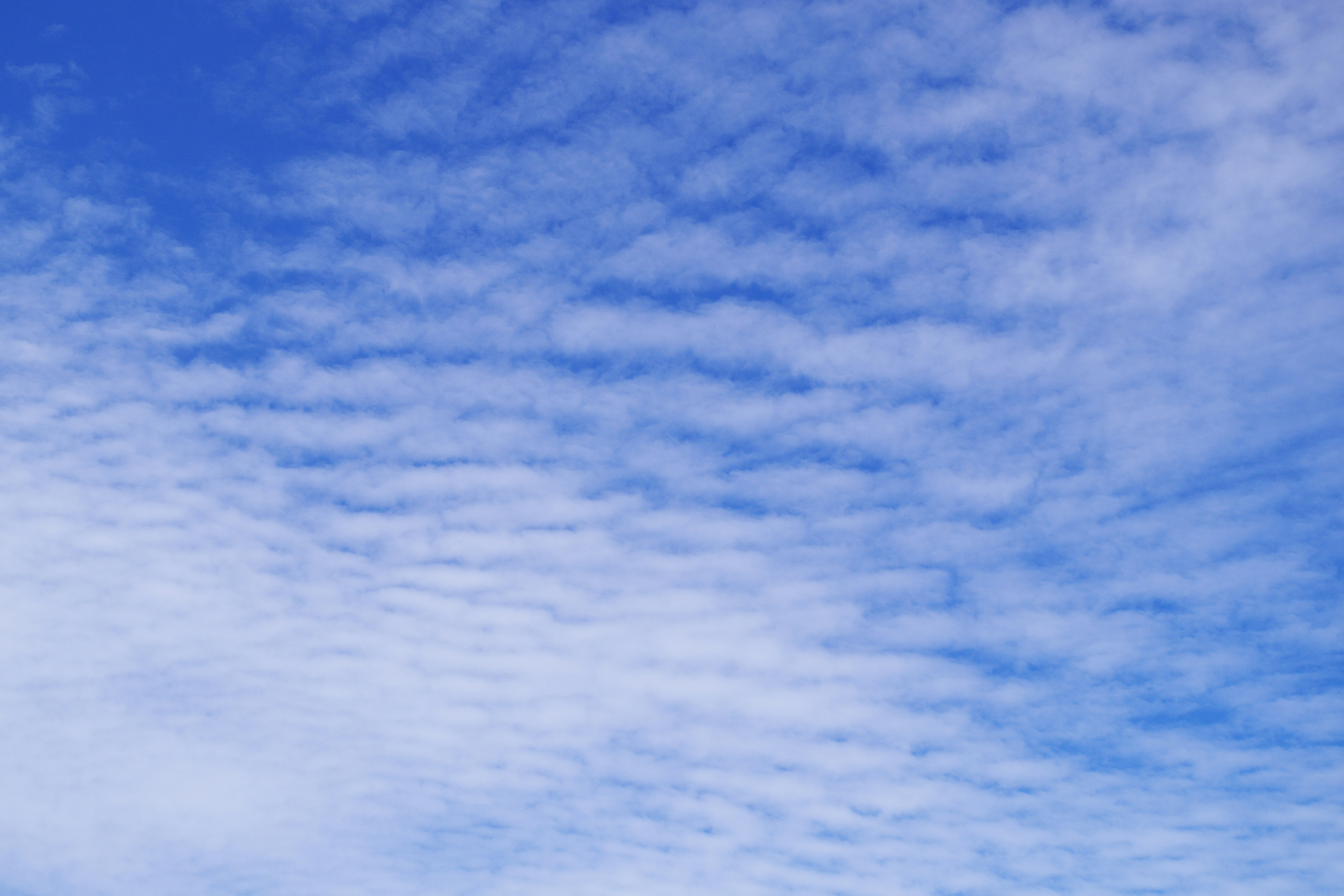 layered clouds across a blue sky