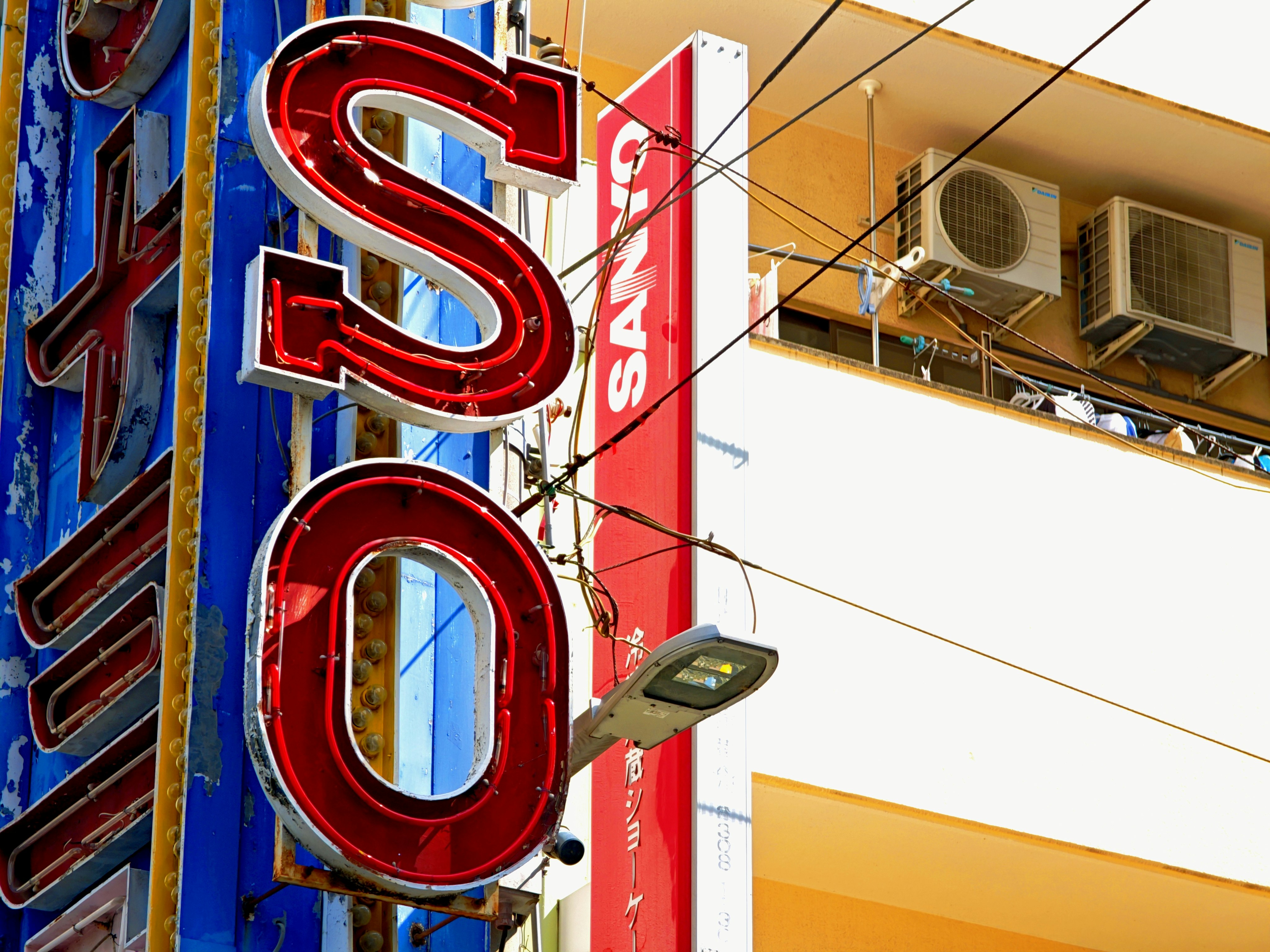 Street corner with Osaka signage and neon letters