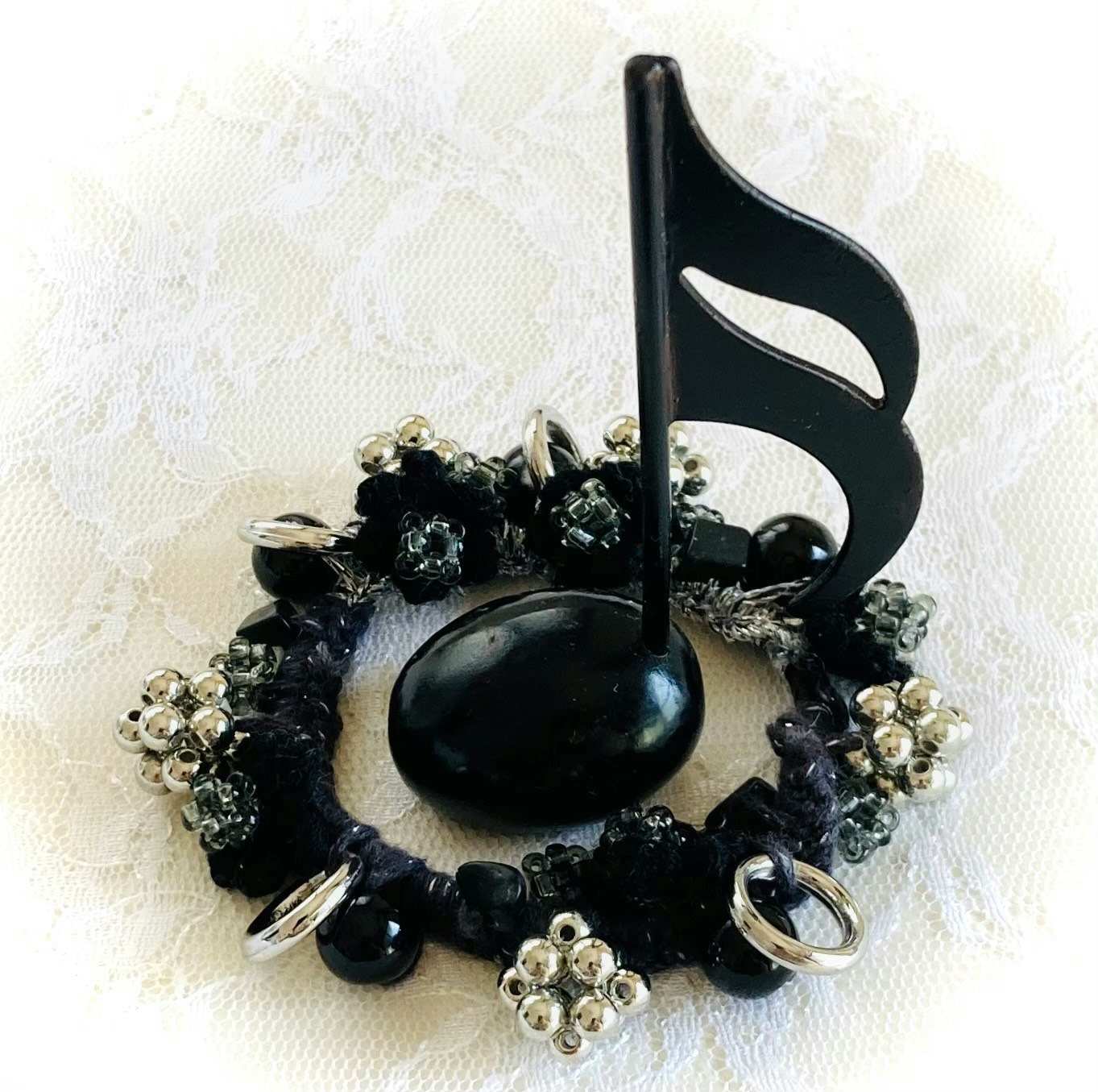 composición de joyería negra con forma de corazón, anillos y dijes