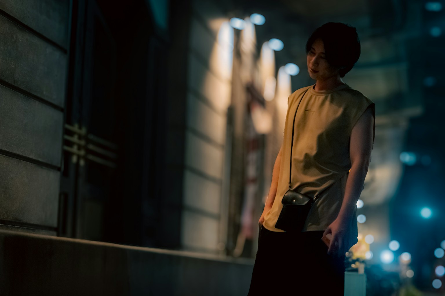 Night portrait of a woman standing under streetlights