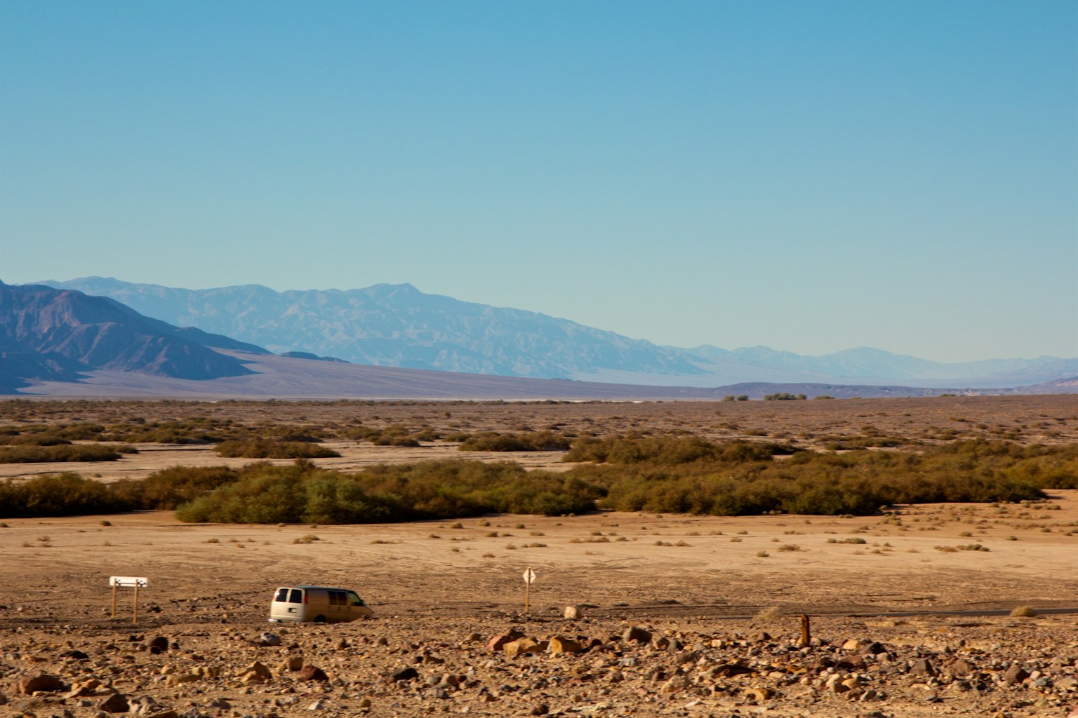 Vast desert landscape with distant mountain silhouettes
