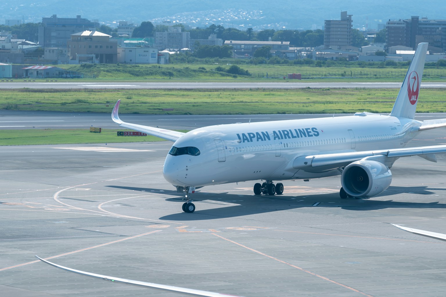 Aereo passeggeri Japan Airlines che taxi sulla pista