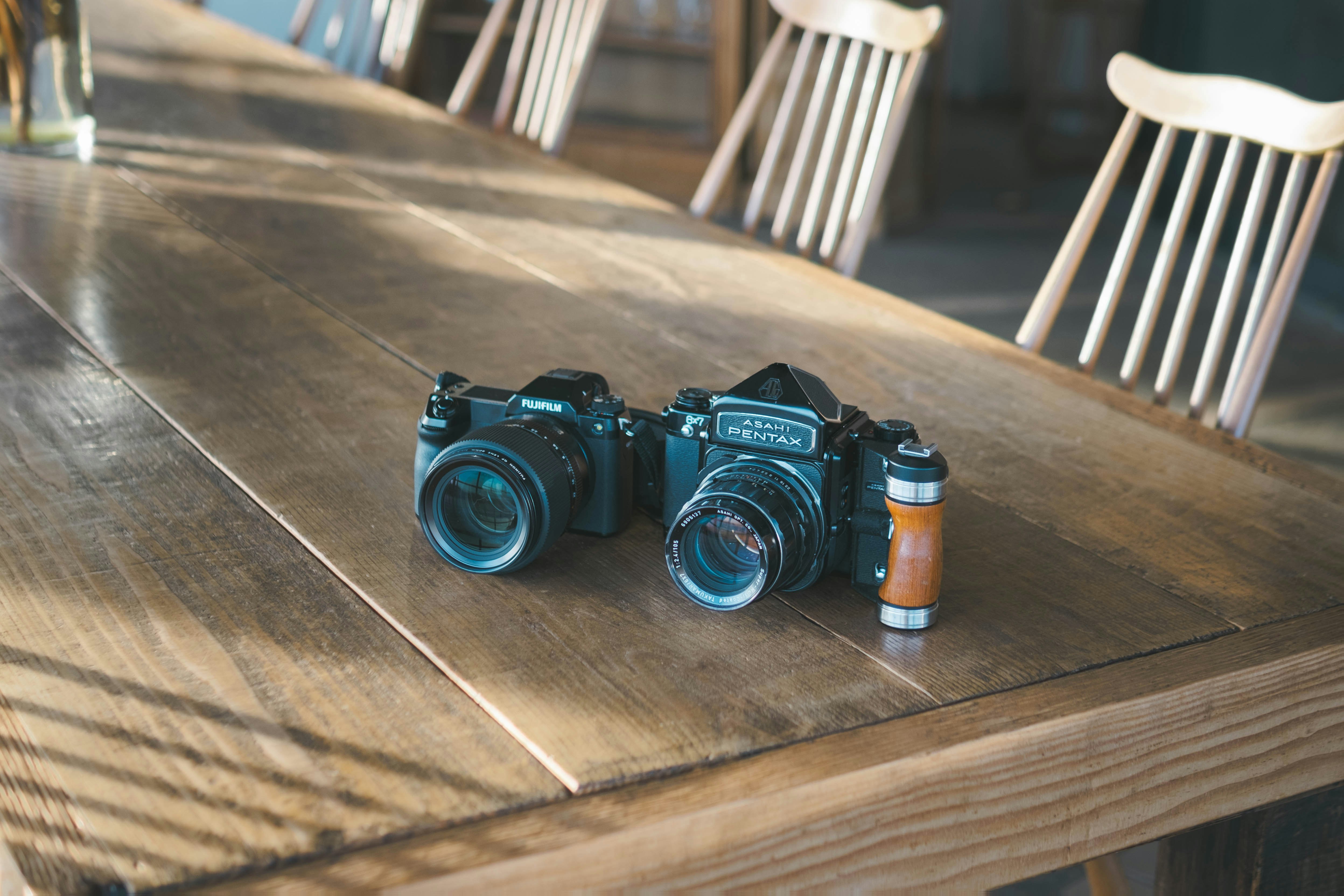 cameras and small accessories on a wooden table