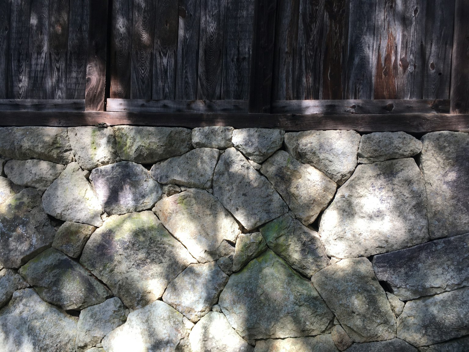 Image showing a stone wall with wooden paneling above
