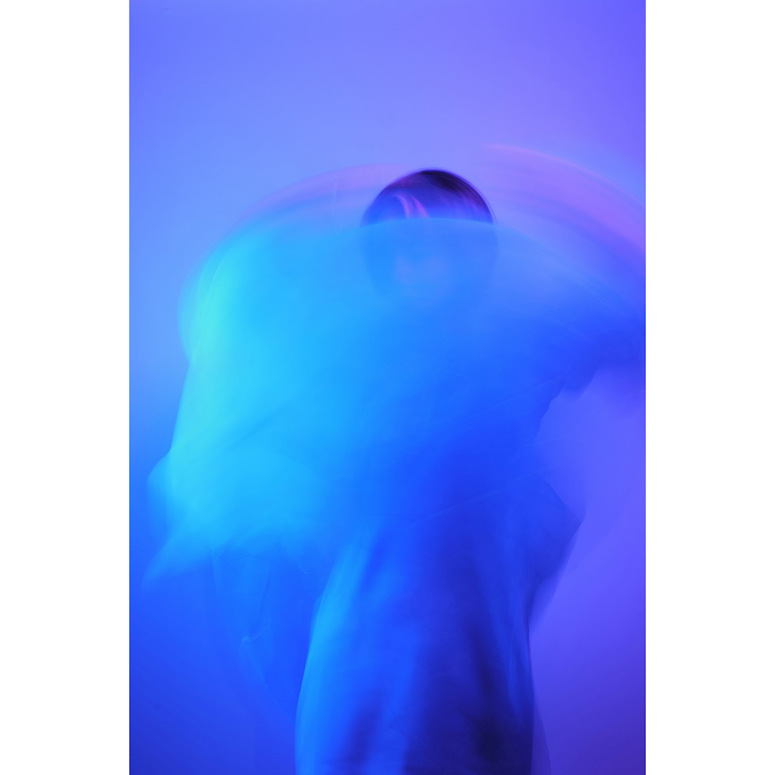 Silhouette of a person moving in blue light