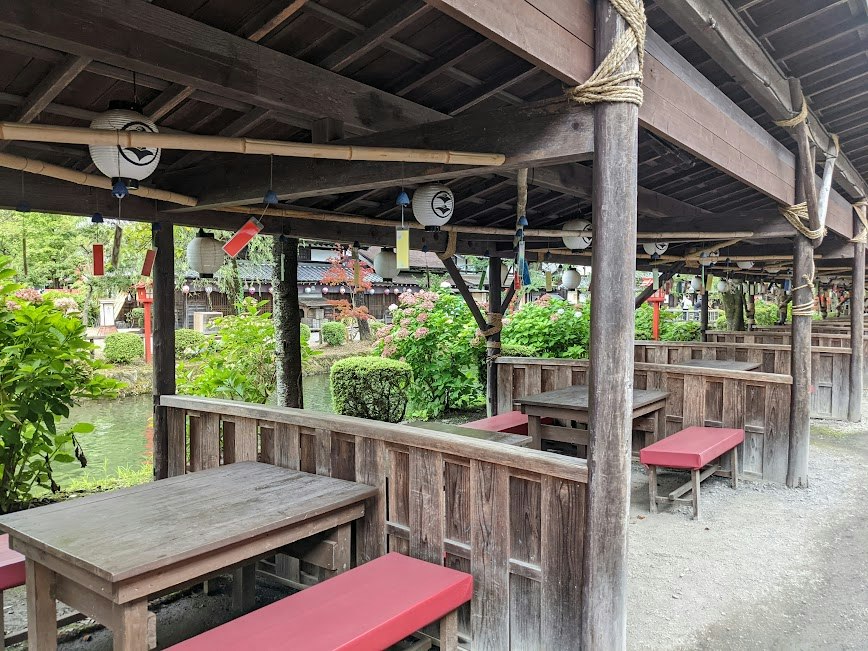 wooden veranda with benches in a garden rest area