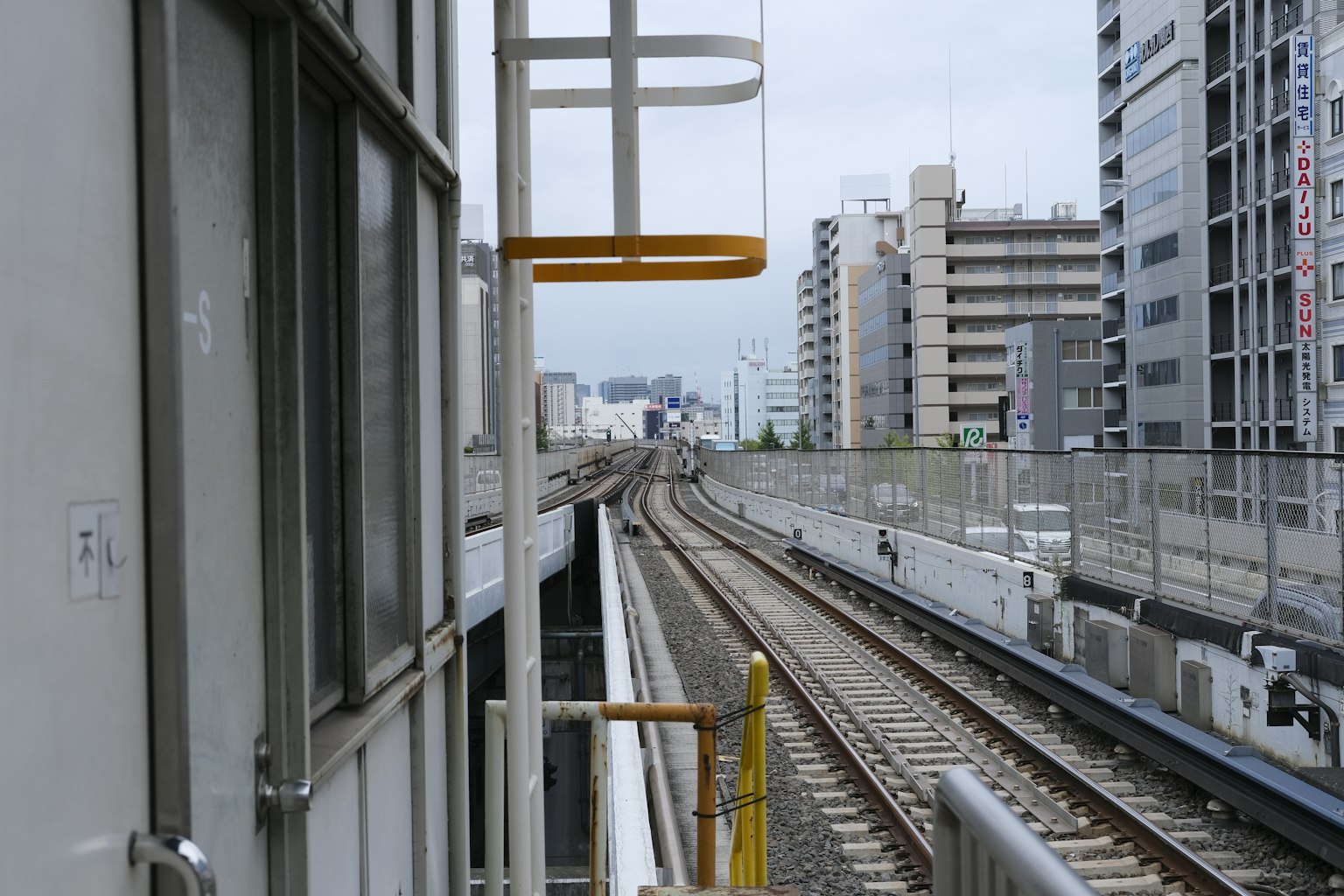 Urban scene featuring train tracks and modern buildings