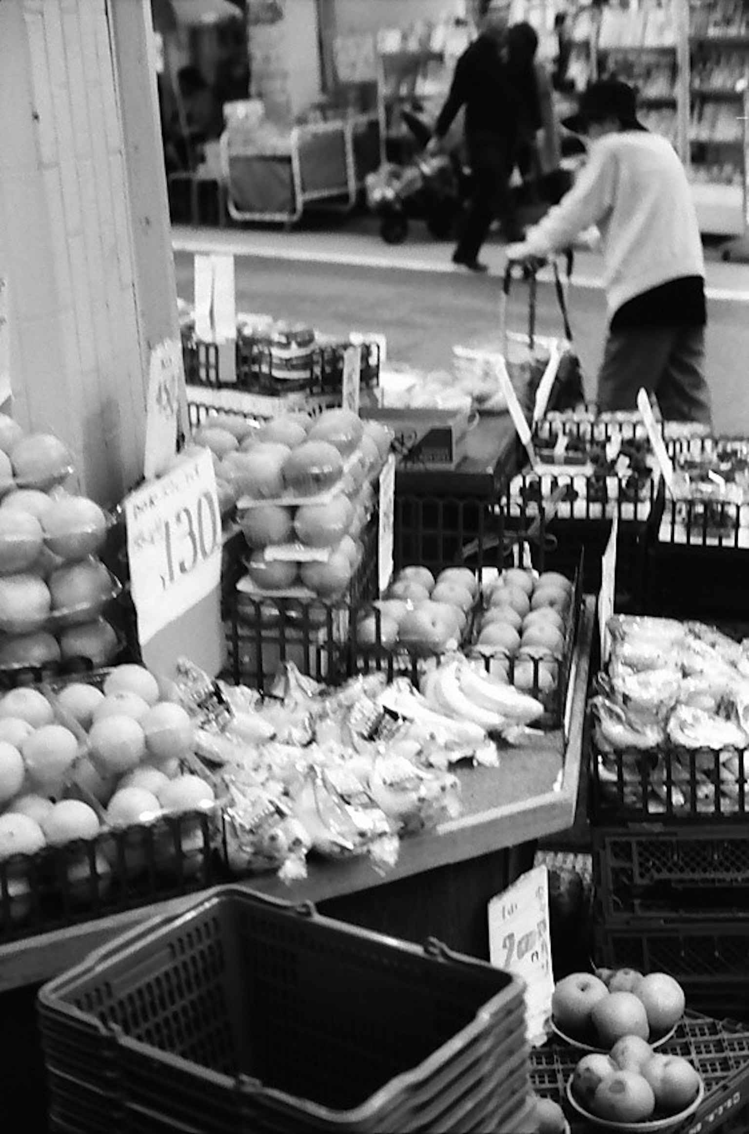 Market scene featuring fruit stalls with apples and bags of produce
