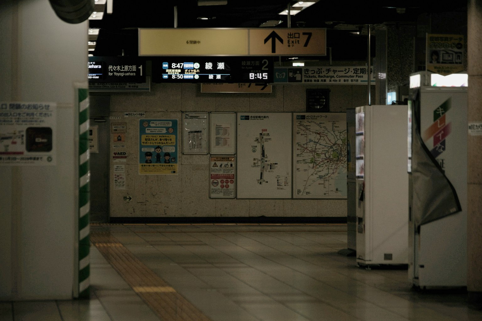 Interior view of a train station featuring signs and maps