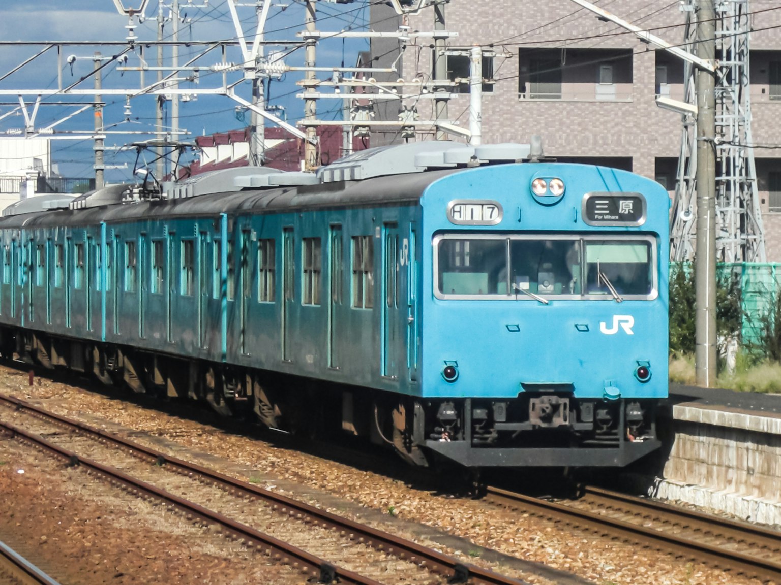 Blue JR train running on the tracks