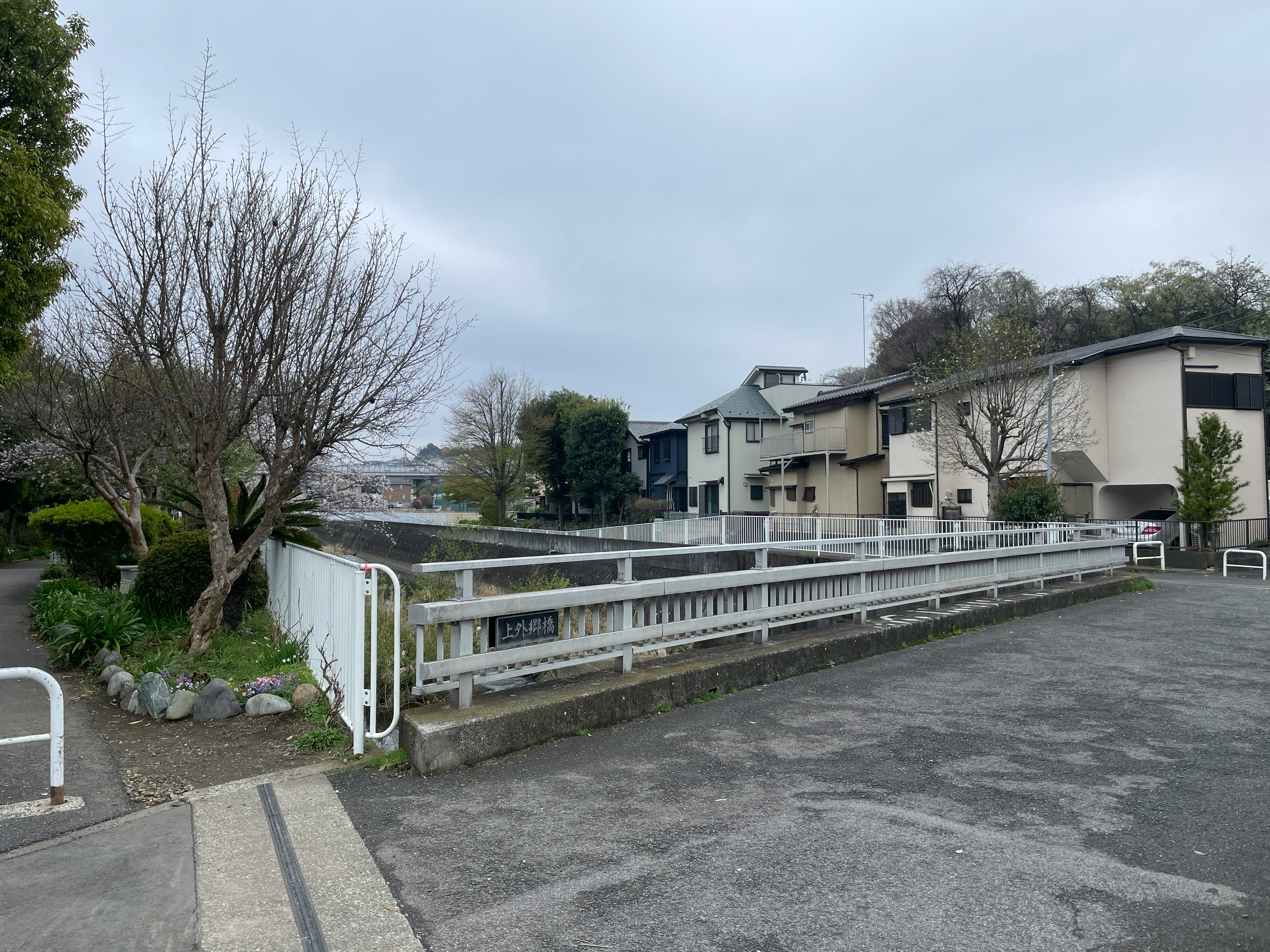 Quiet residential area featuring a bridge and surrounding trees