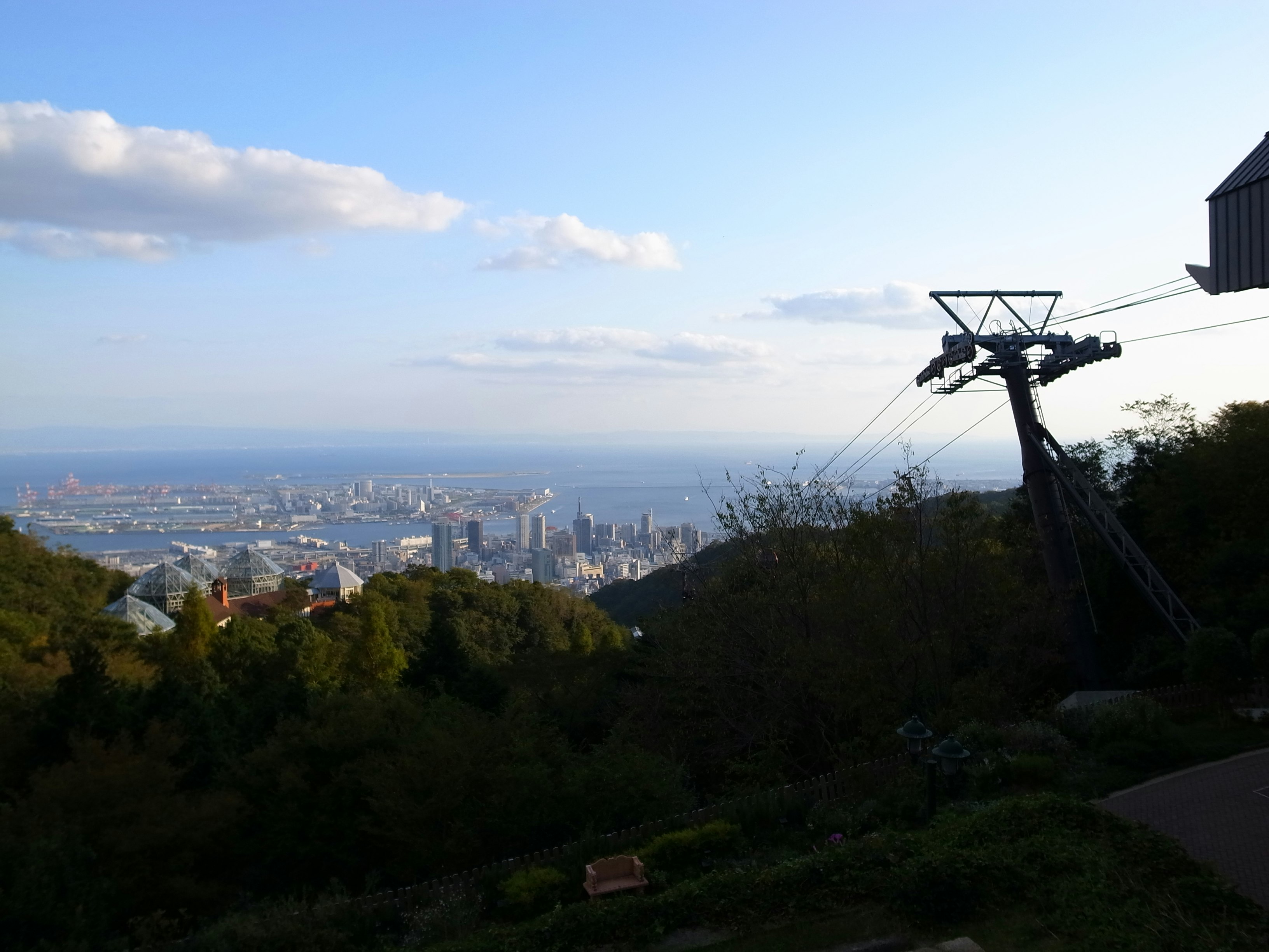 丘の上から見下ろす街並みと遠くの海の眺望