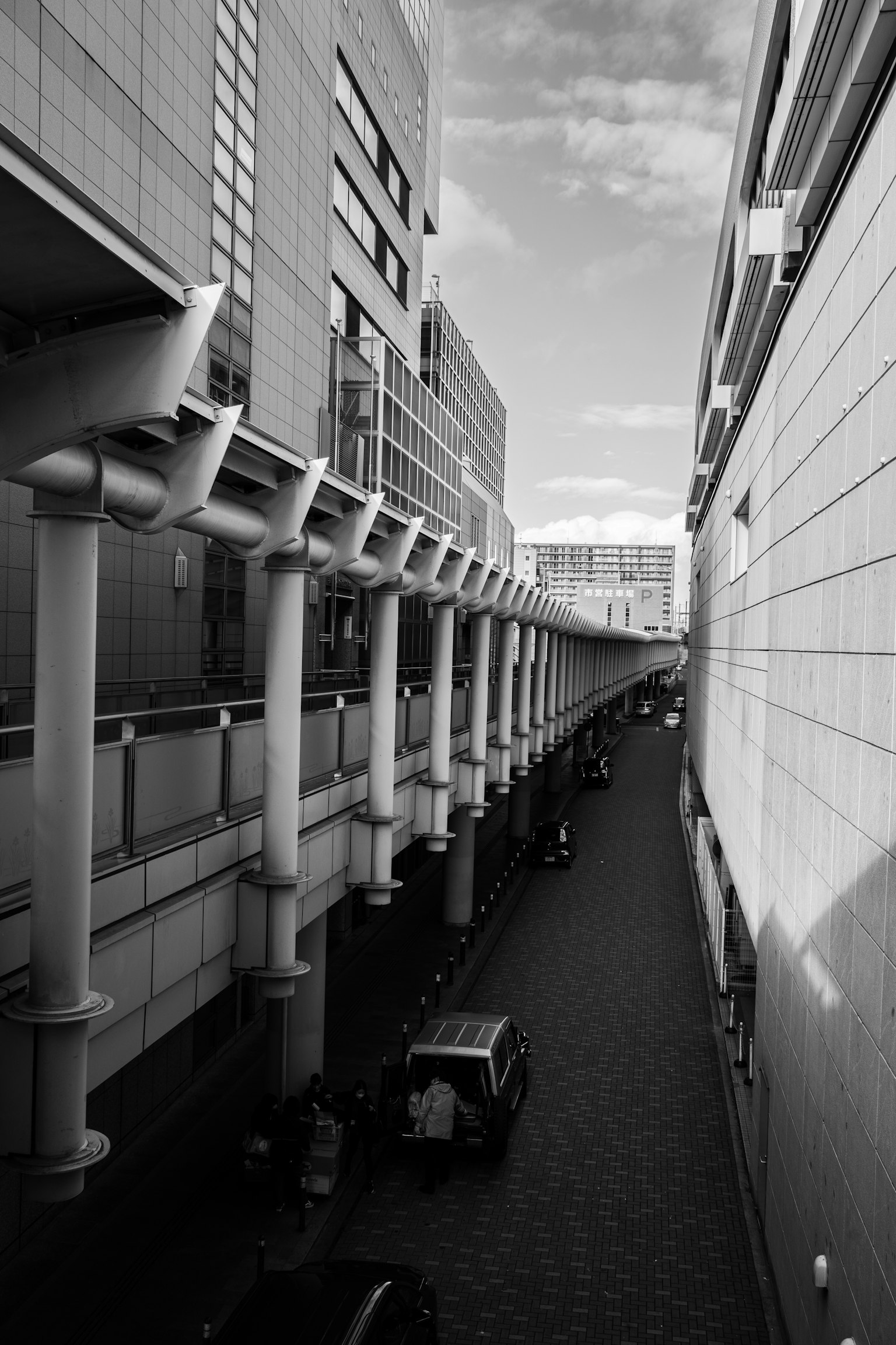 Narrow street with high-rise buildings in black and white