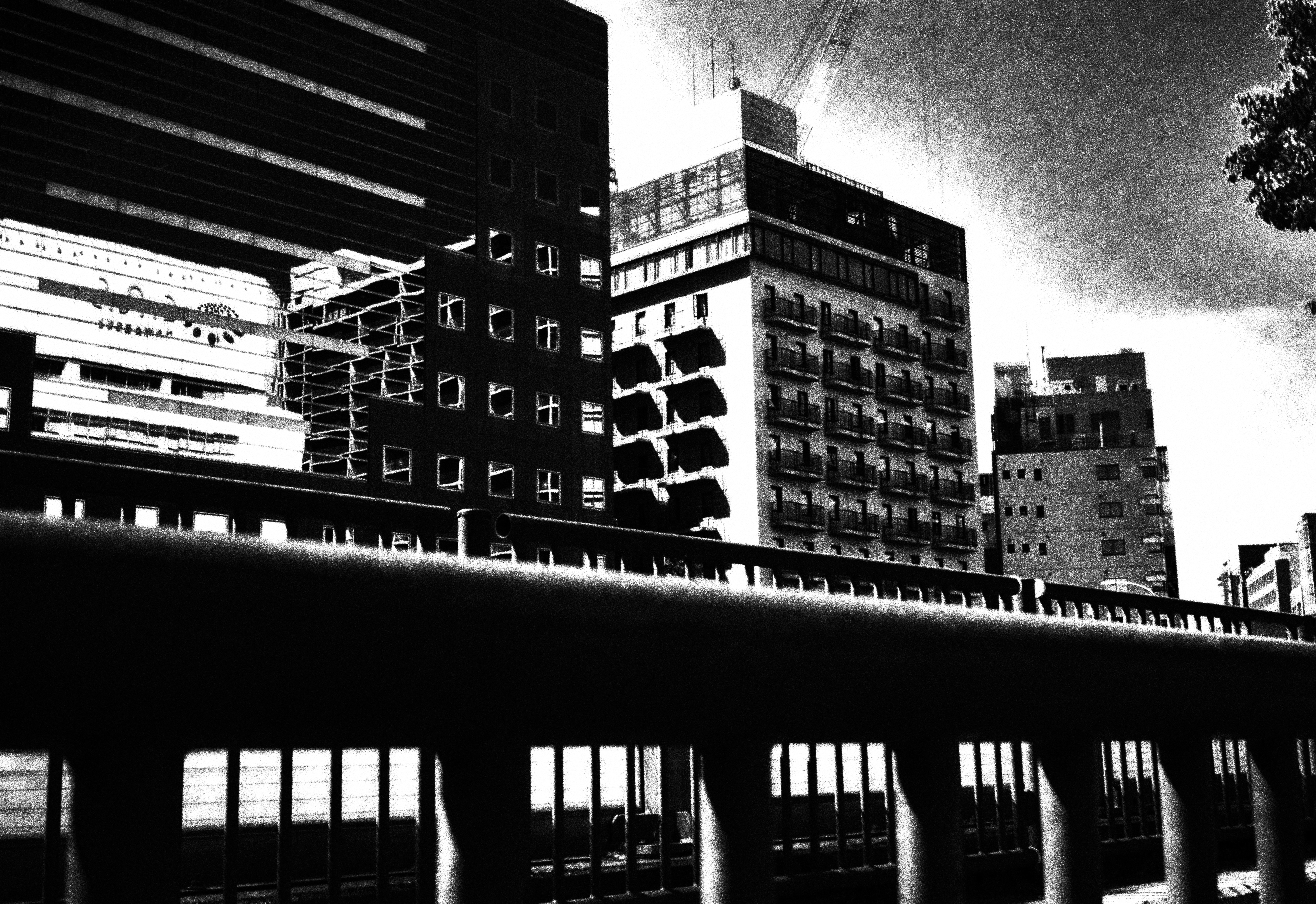 Urban skyline with stacked high-rise buildings and a barred railing