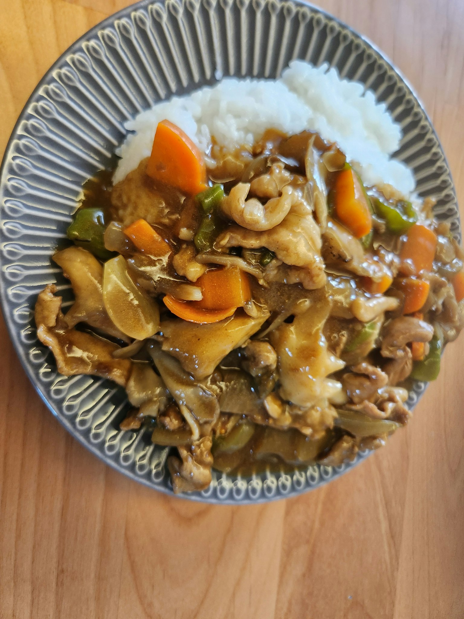 Plate of stir-fried vegetables and meat served with white rice